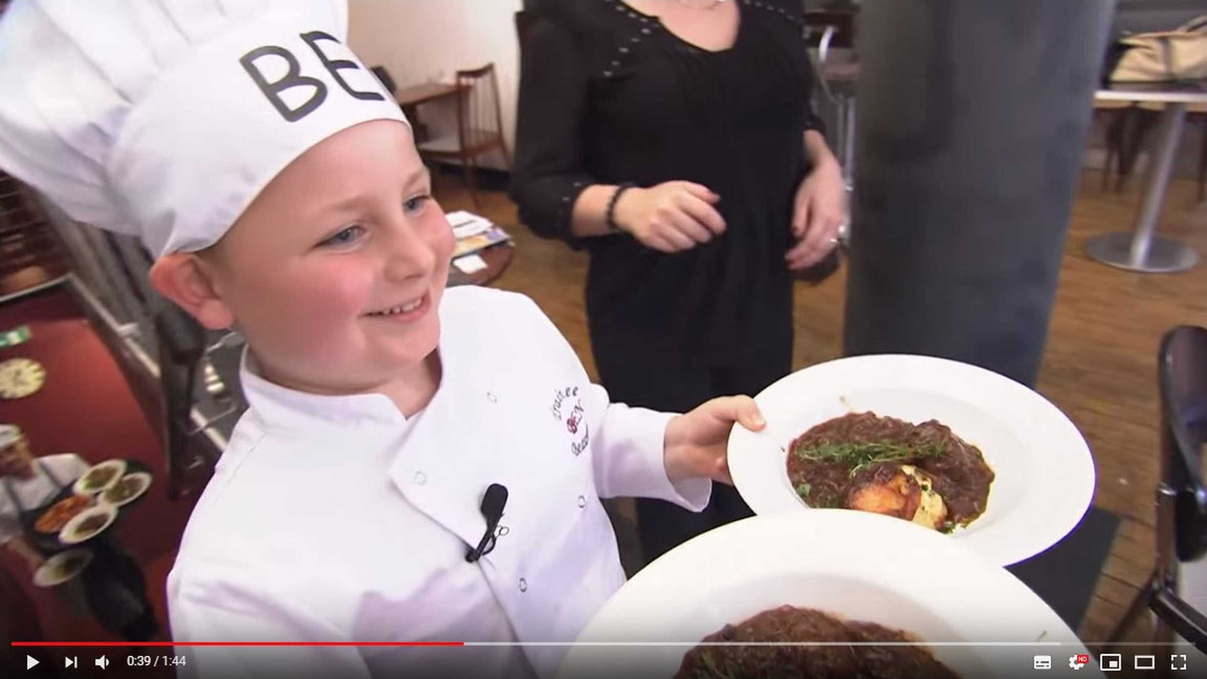 Wish child, Ben serving two plates of food that he prepared on his wish to be a chef for the day.