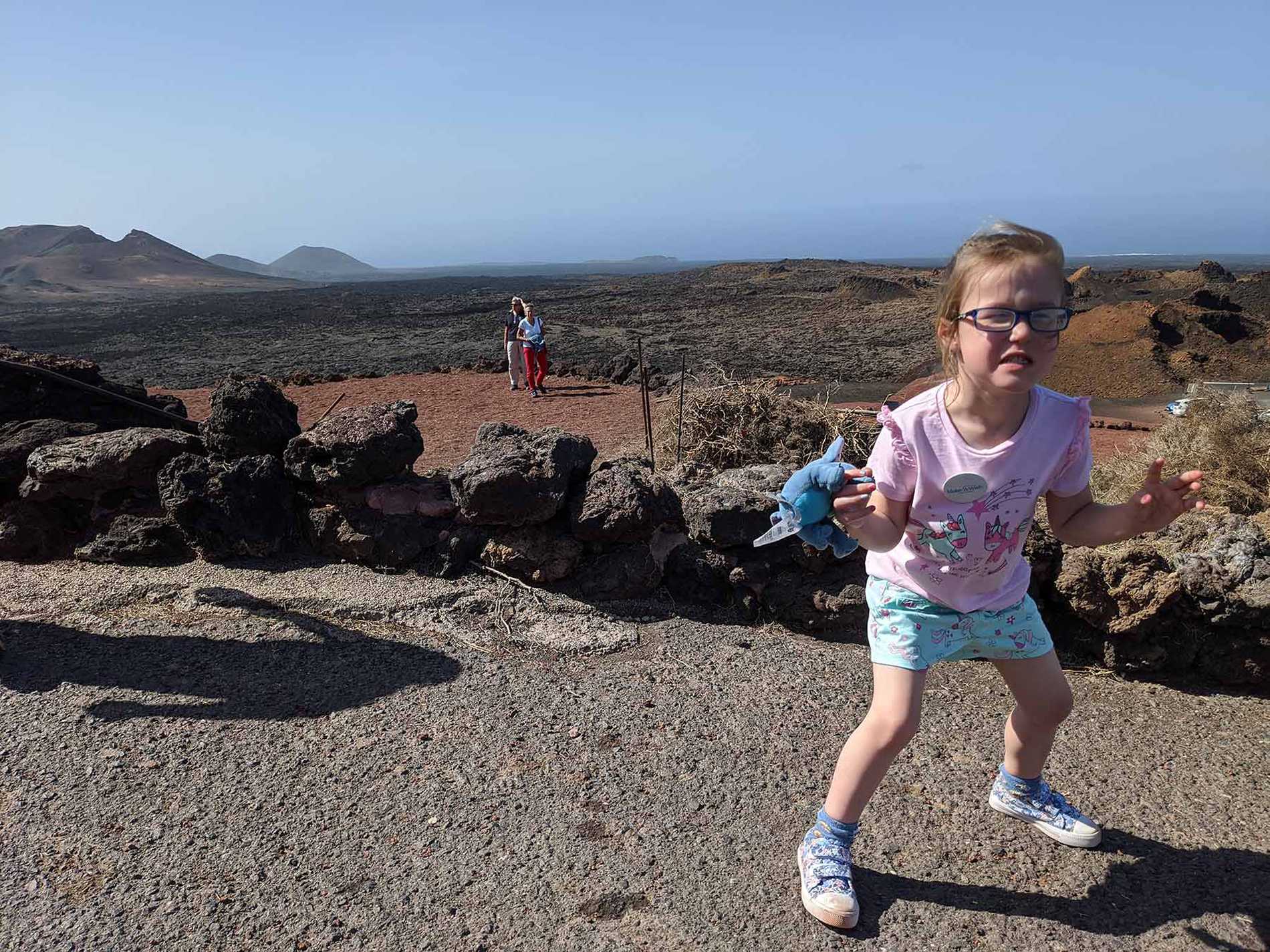 Hope during her trip to see see a volcano, with rugged scenery in the background.
