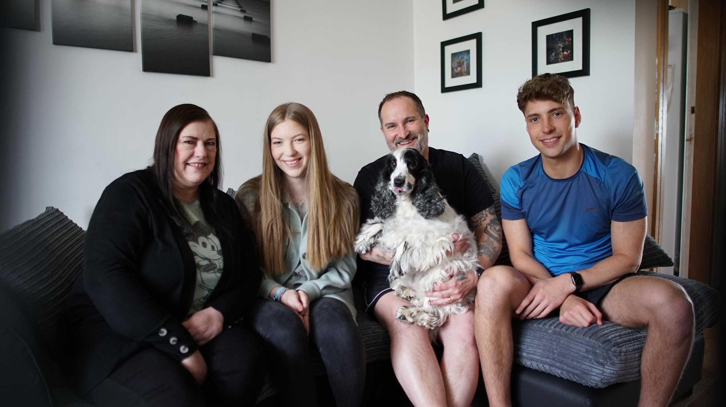 Hayley sitting on the sofa with her mum, dad, brother and the family dog.