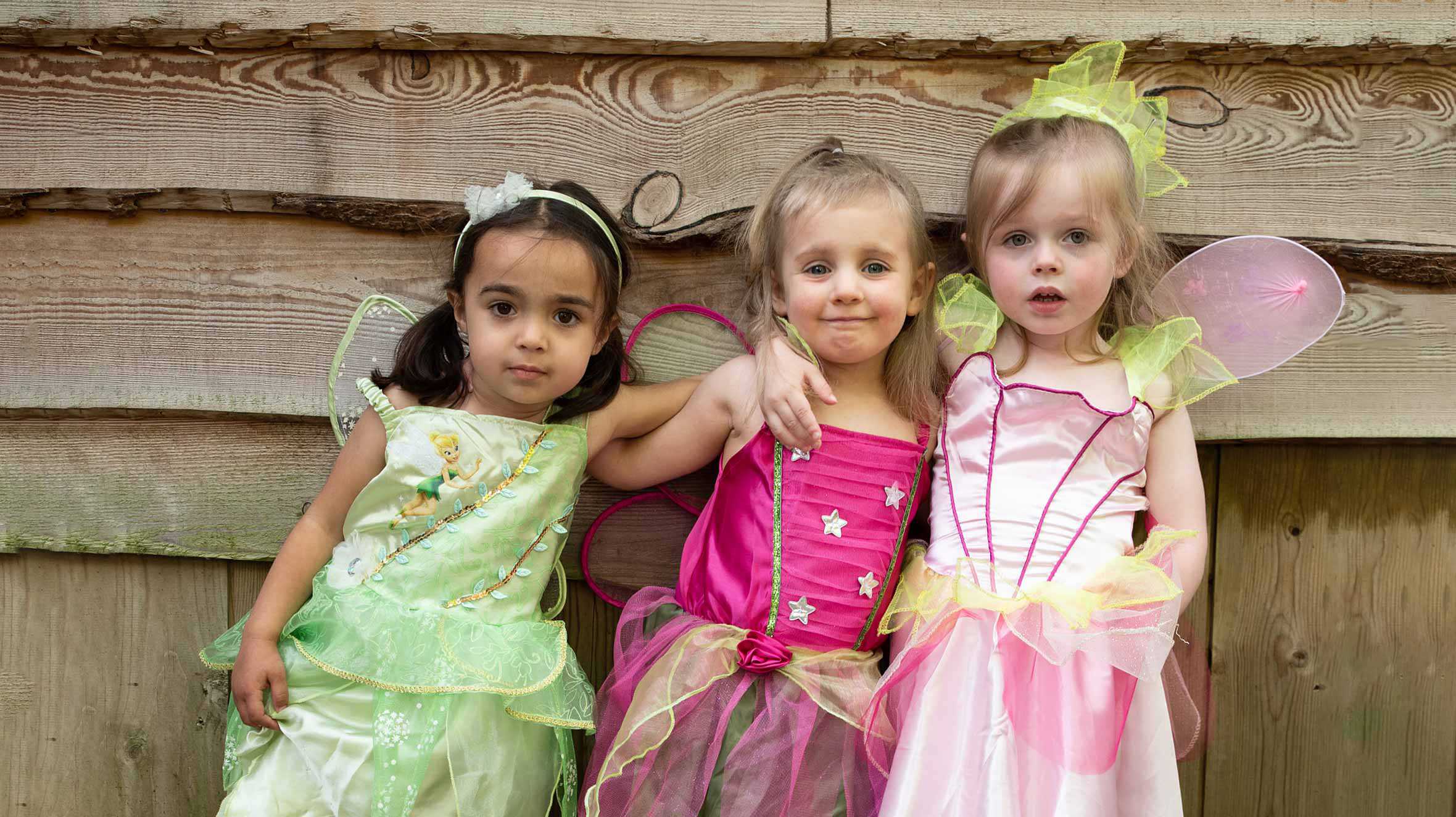 Elsie and her cousins standing outside the treehouse in their fairy costumes