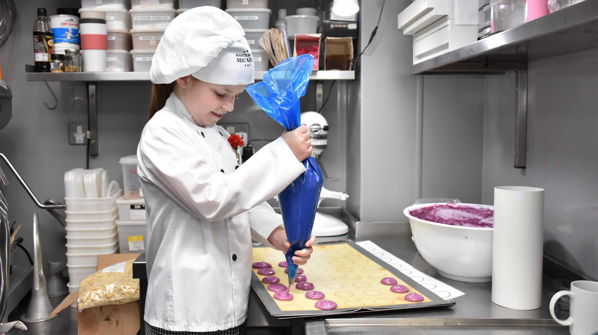 Micaela preparing a tray of macaroons.