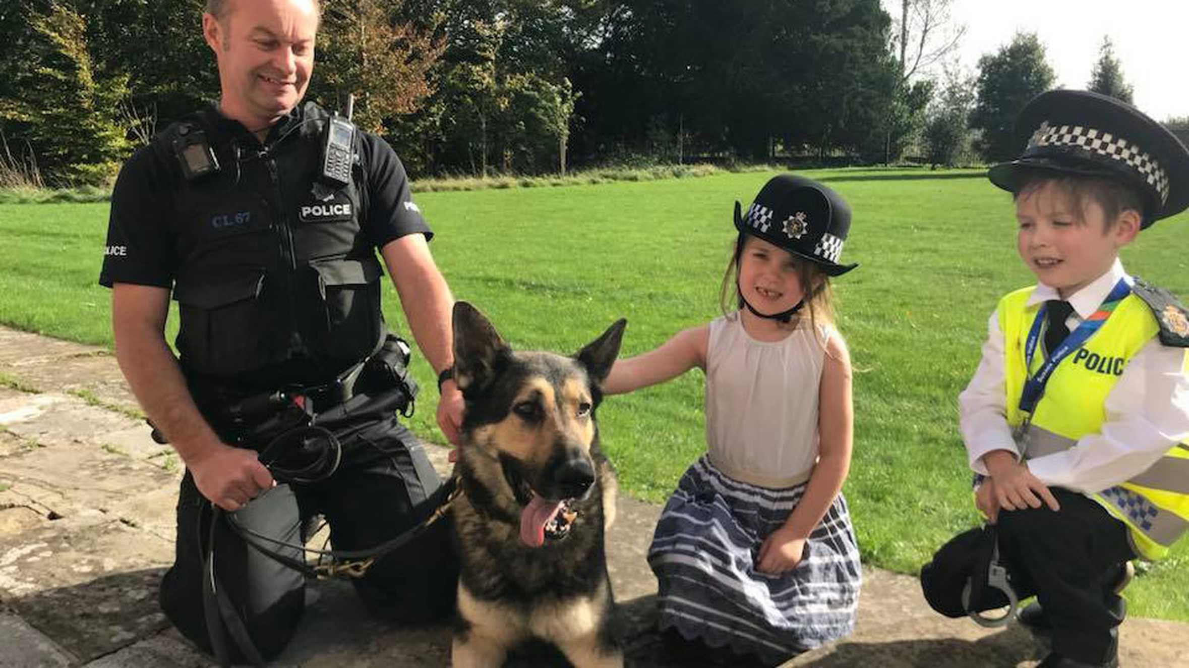 Danny and his sister with a police dog