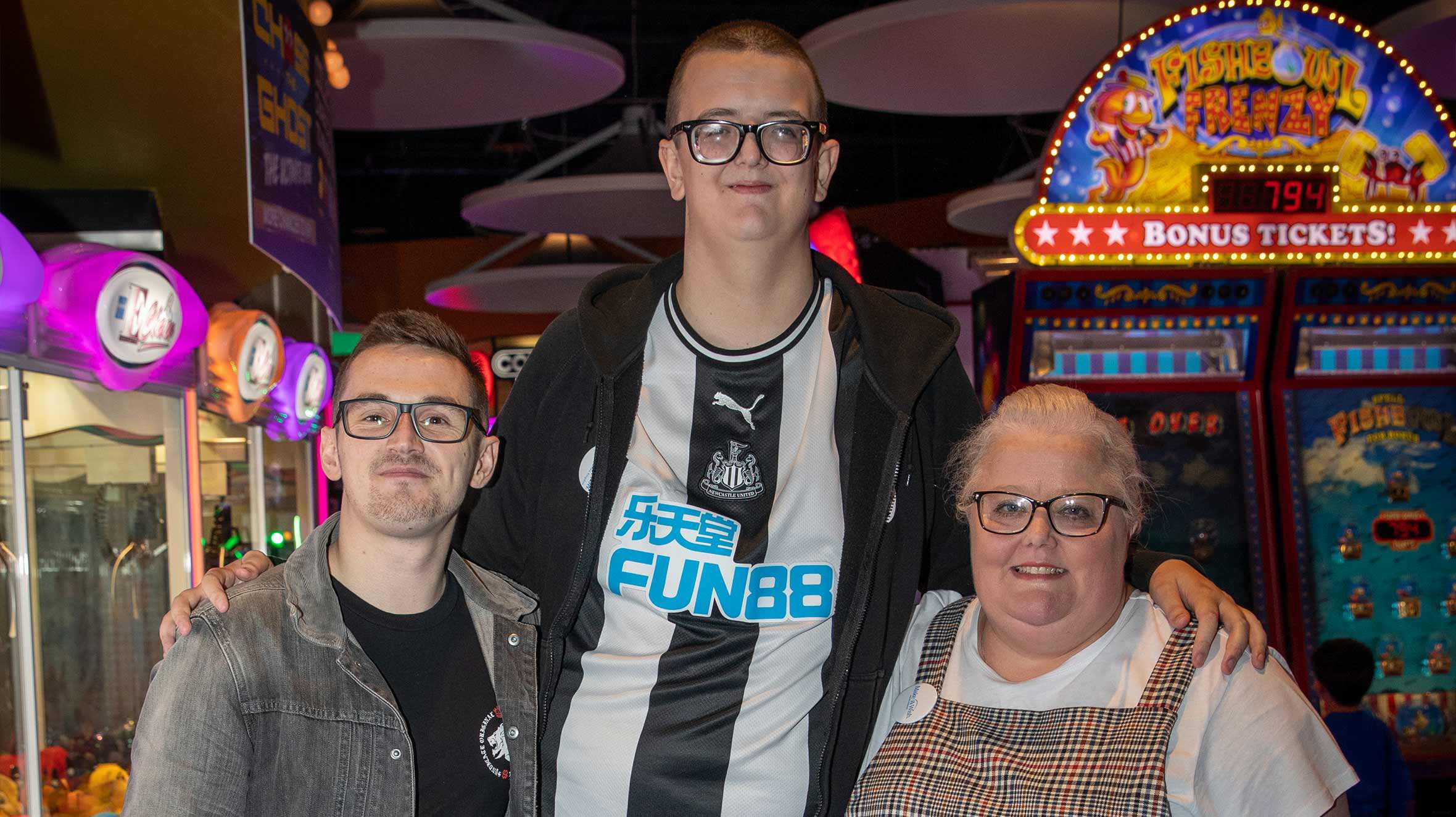 Christopher standing in between his mum and Tom Cassell.