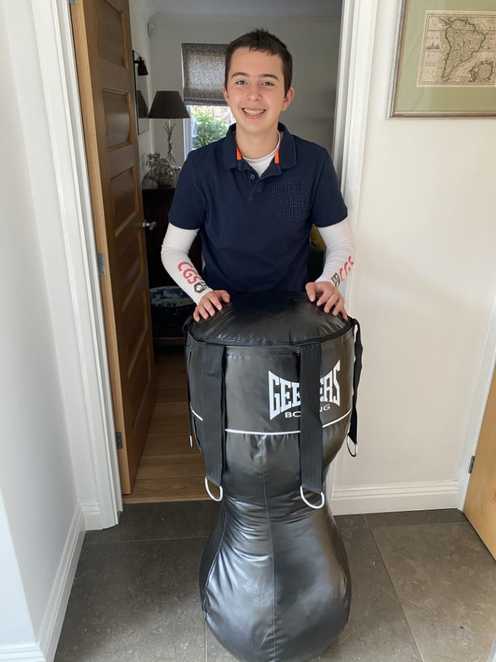 A happy Darshan taking delivery of a new punchbag.