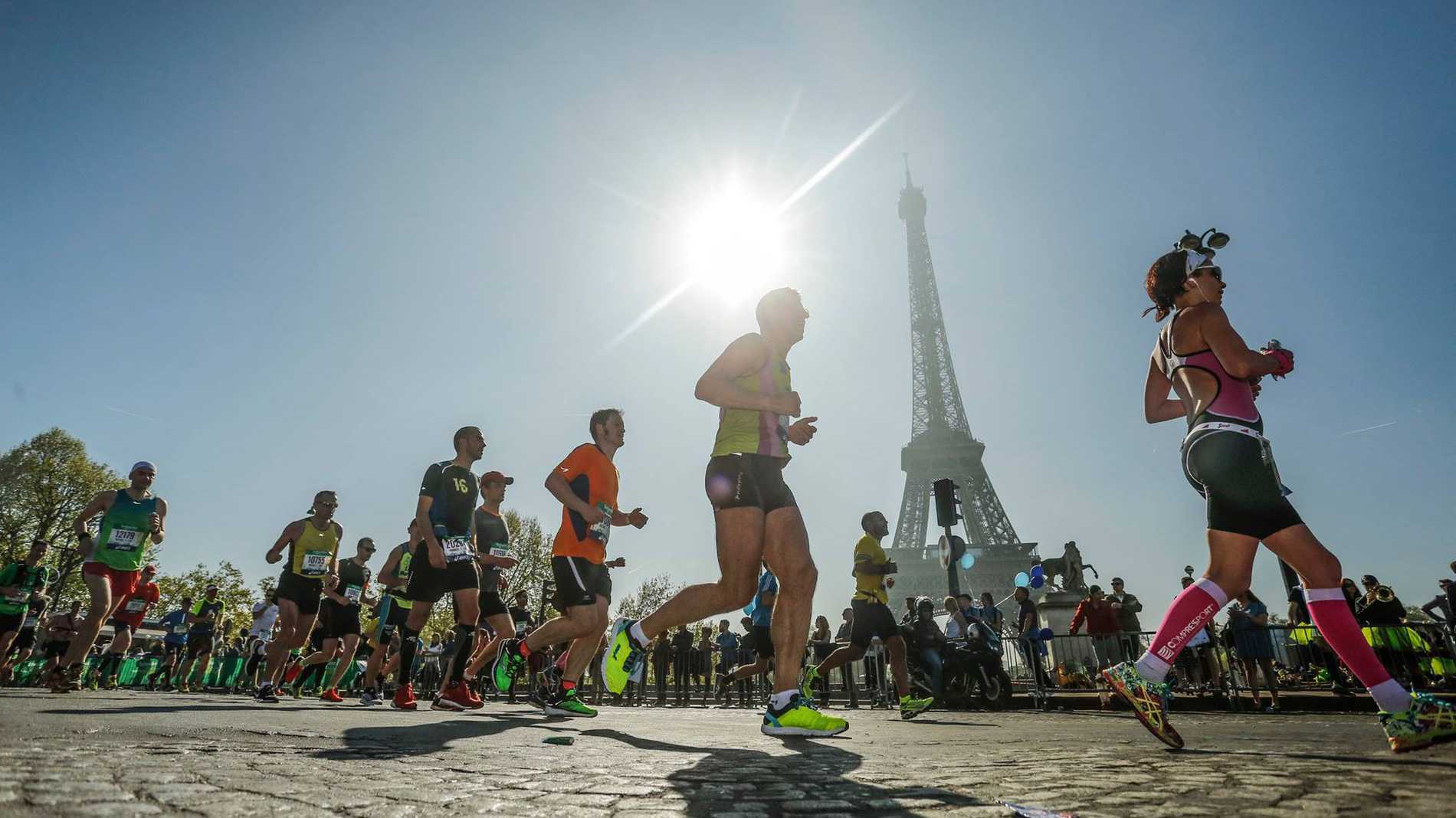 Runners passing the iconic Eiffel Tower during the Paris Marathon.