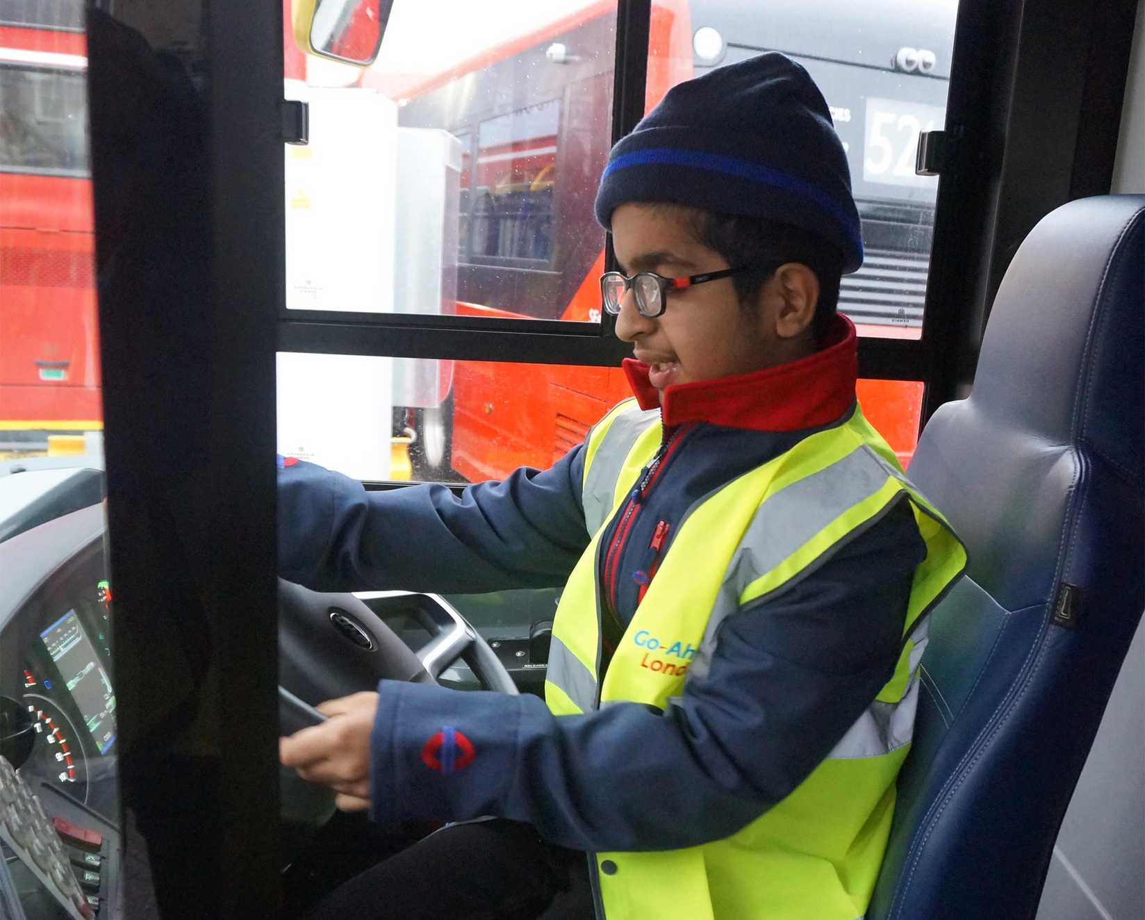 Krish at the wheel of a bus