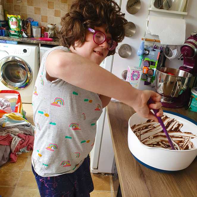 Dakota mixing ingredients in a large bowl.