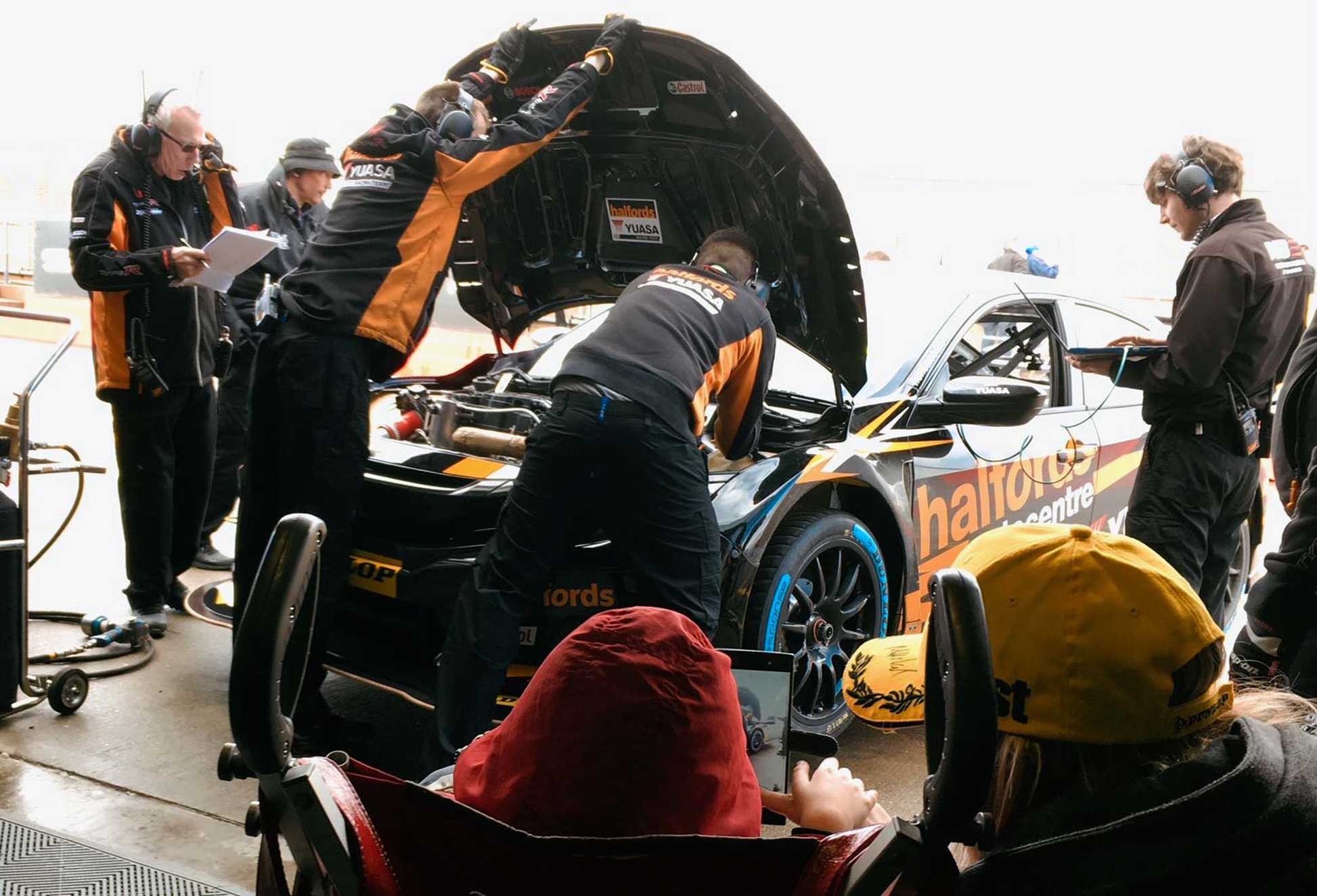 Zaid watching engineer's work on the car