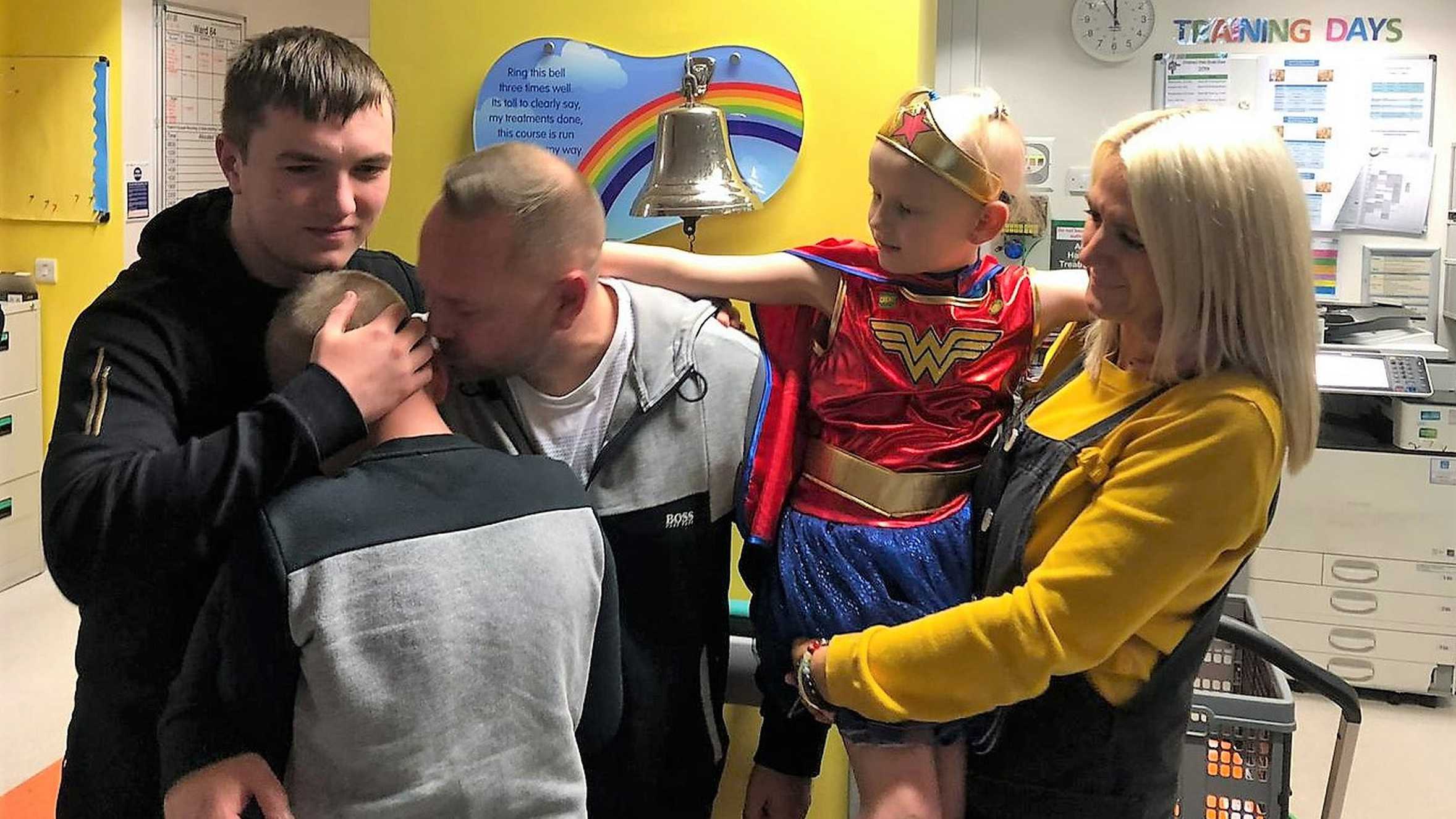 Isla and her family ringing the end of treatment bell.