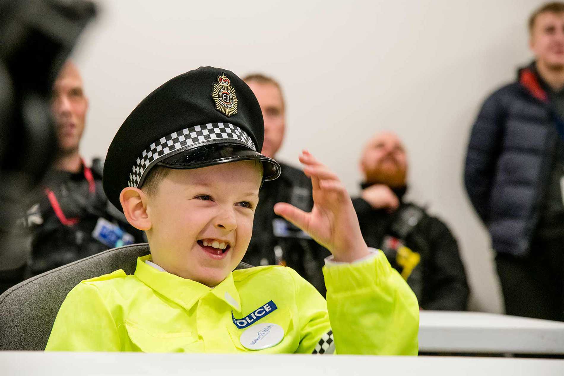Allan smiling with police officers in the background.