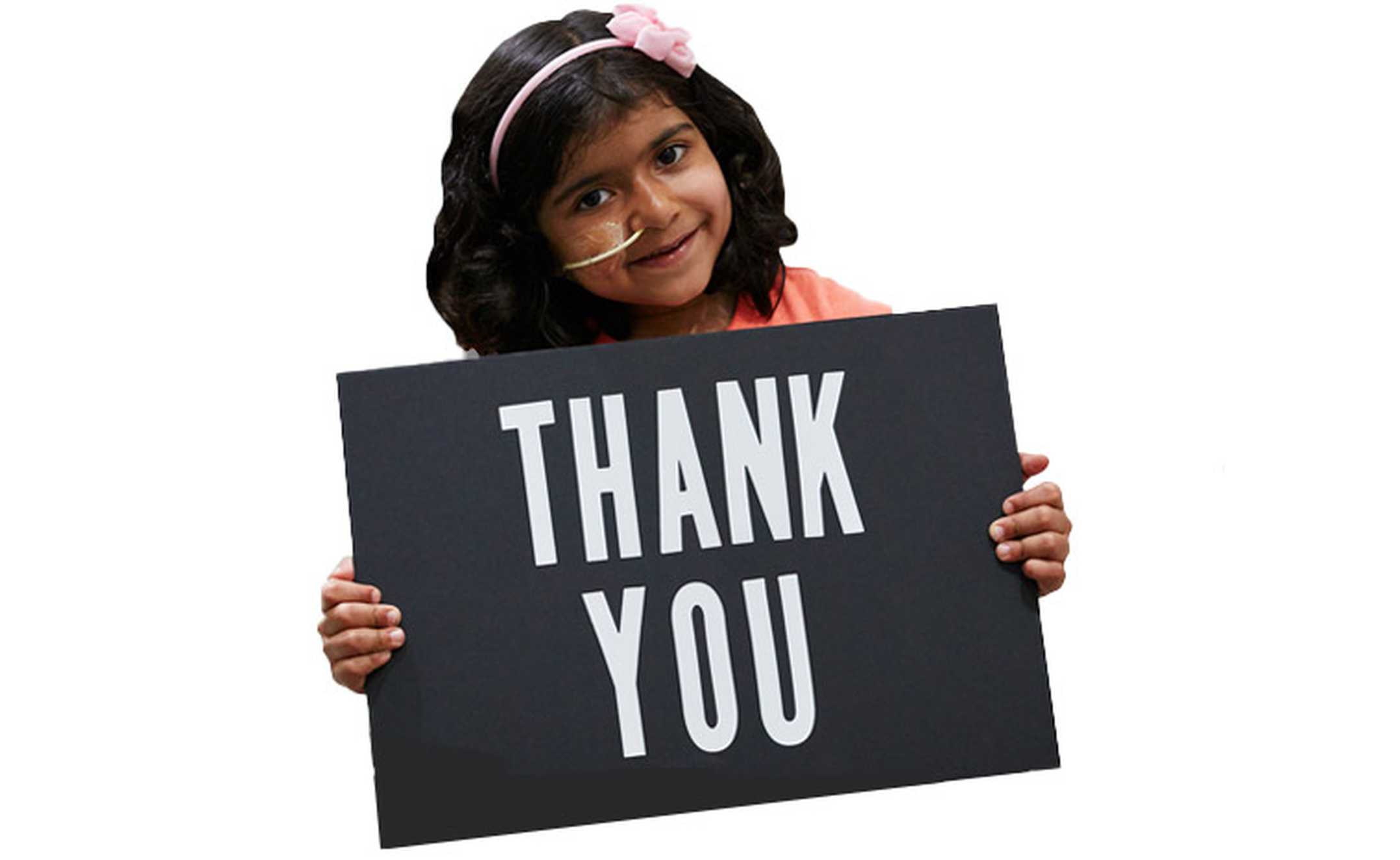 Wish child, Sophia holding up a thank you sign.