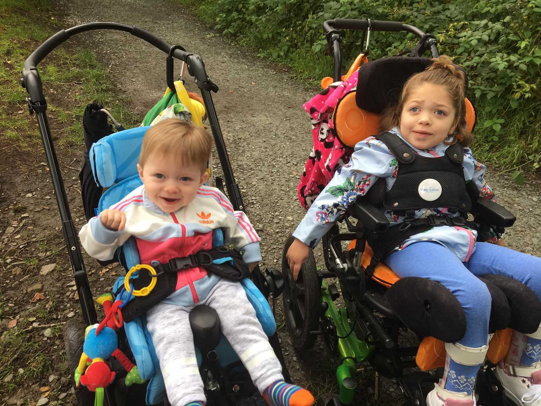 Aubree sitting next to her brother on a path during her wish.