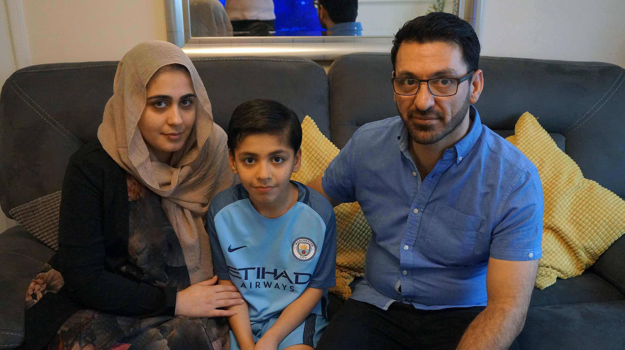 Idris on the sofa with his mum and dad