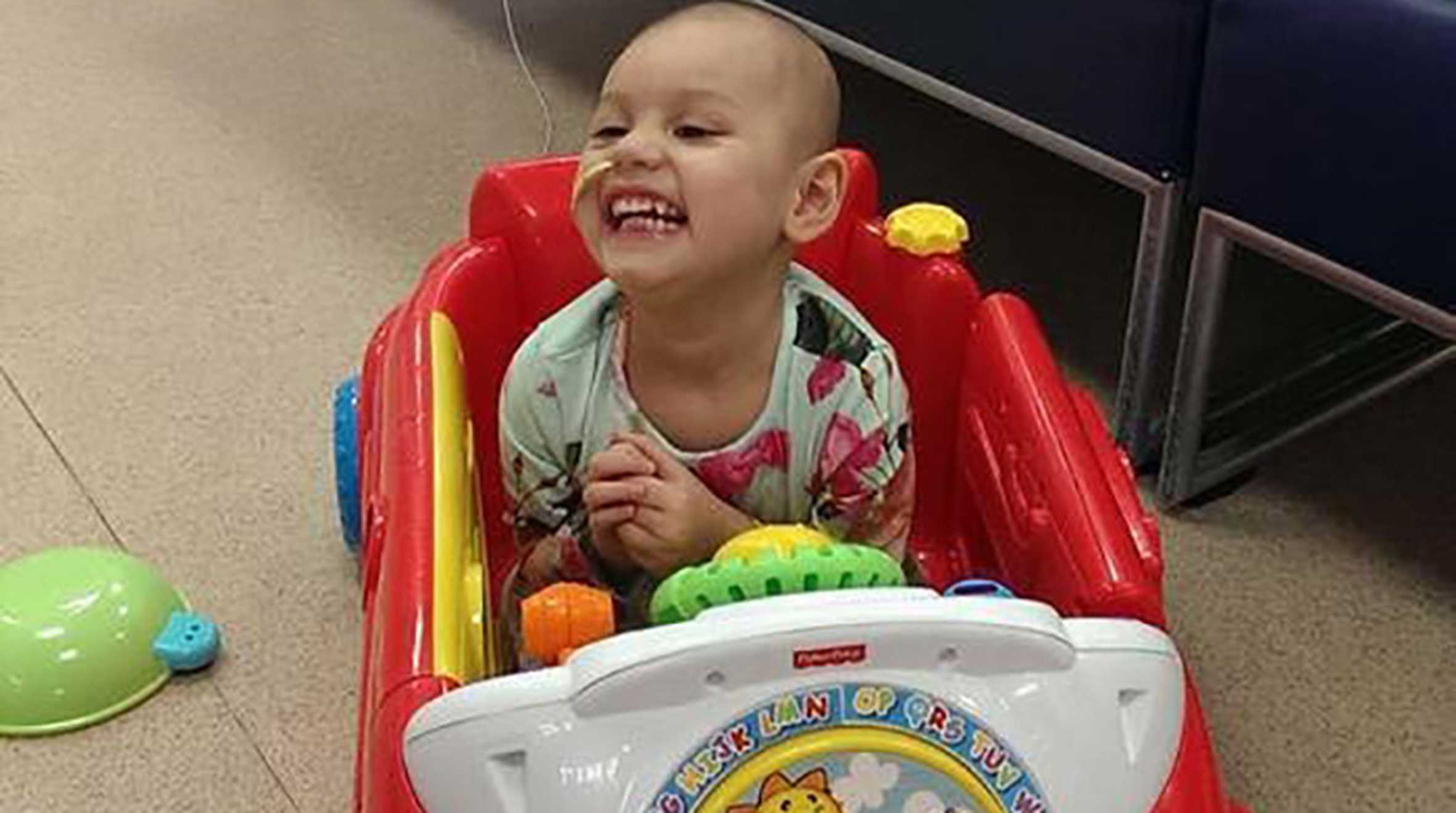 Lexi laughing and playing in hospital