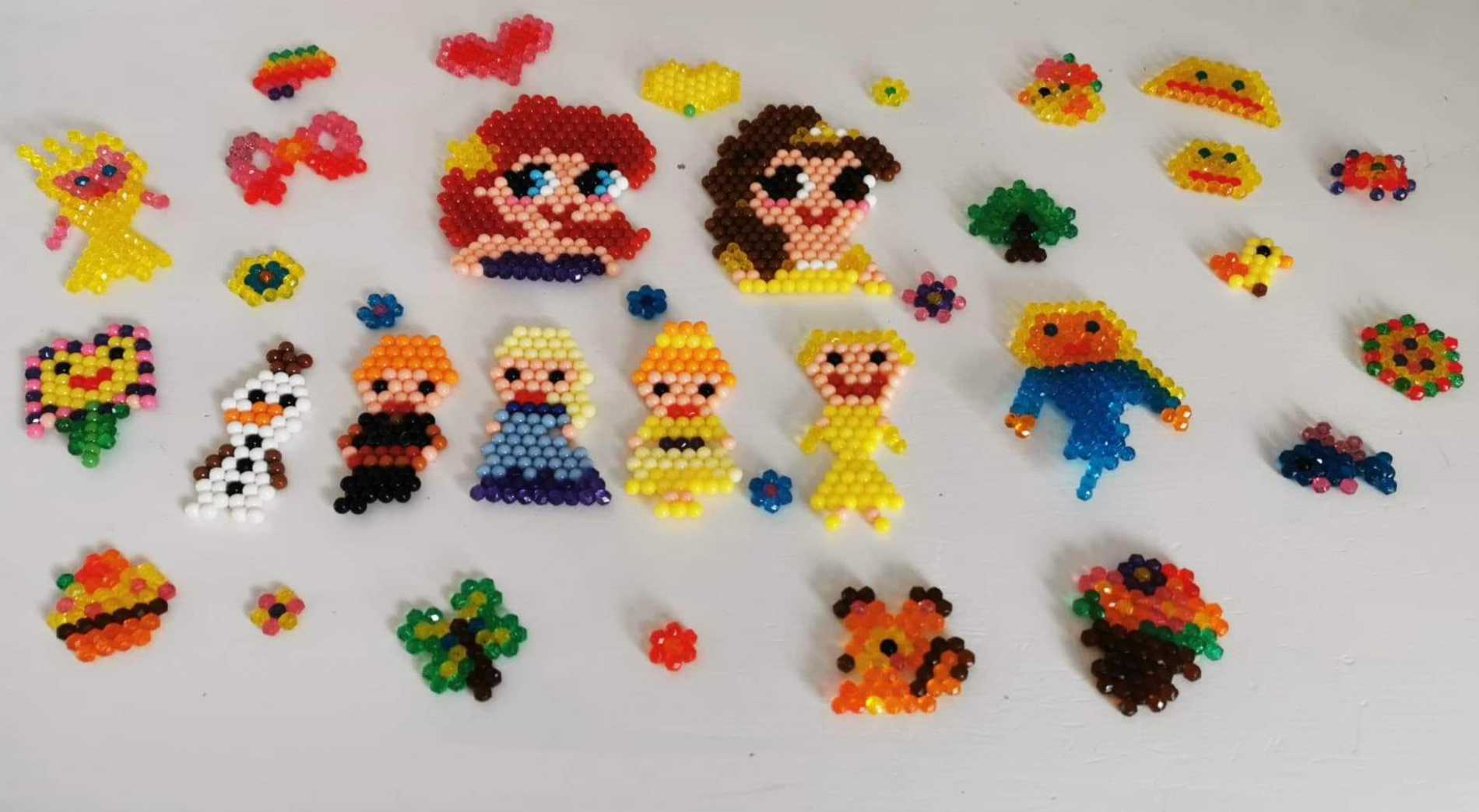 A collection of colourful characters, created from beads by wish child, Bethany.