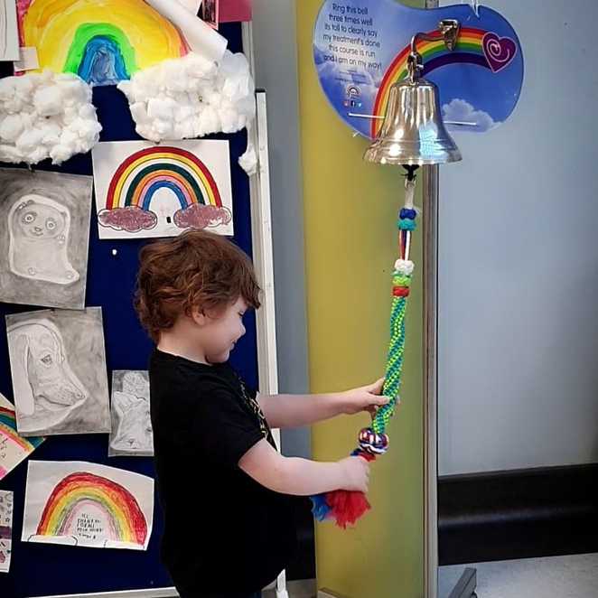 Aaron ringing the end of treatment bell after his first round of treatment, prior to his relapse.