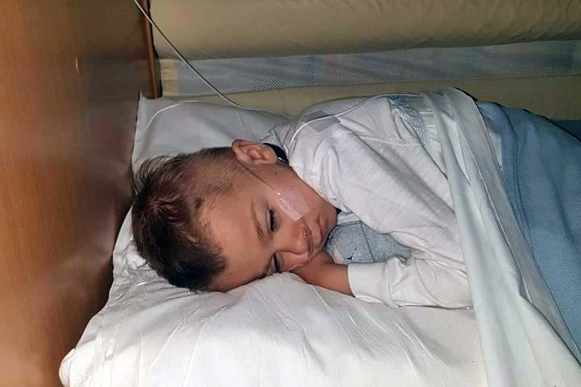 Jack asleep in a hospital bed with a feeding tube in his nose during treatment for his condition.