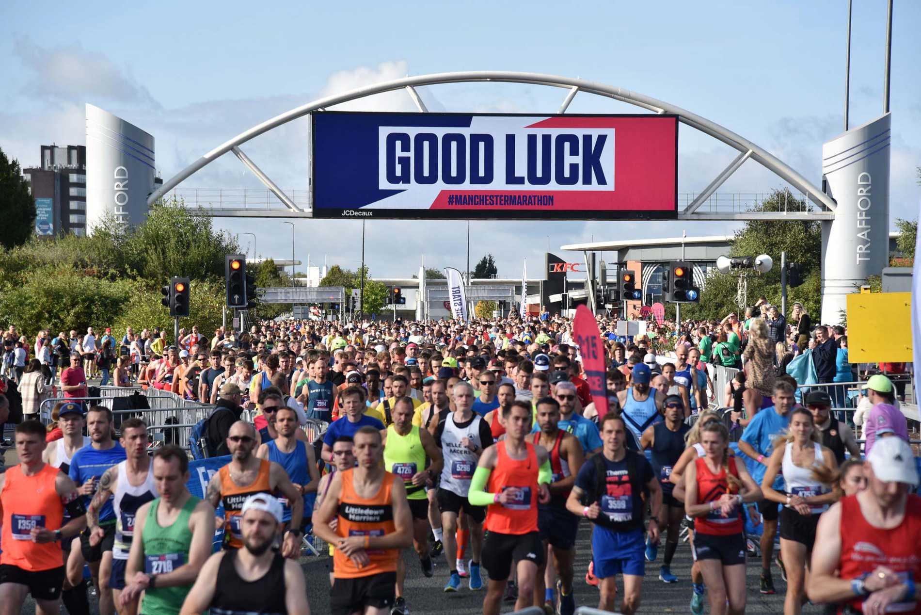 A crowd of Manchester Marathon participants making their way past the Trafford Centre.