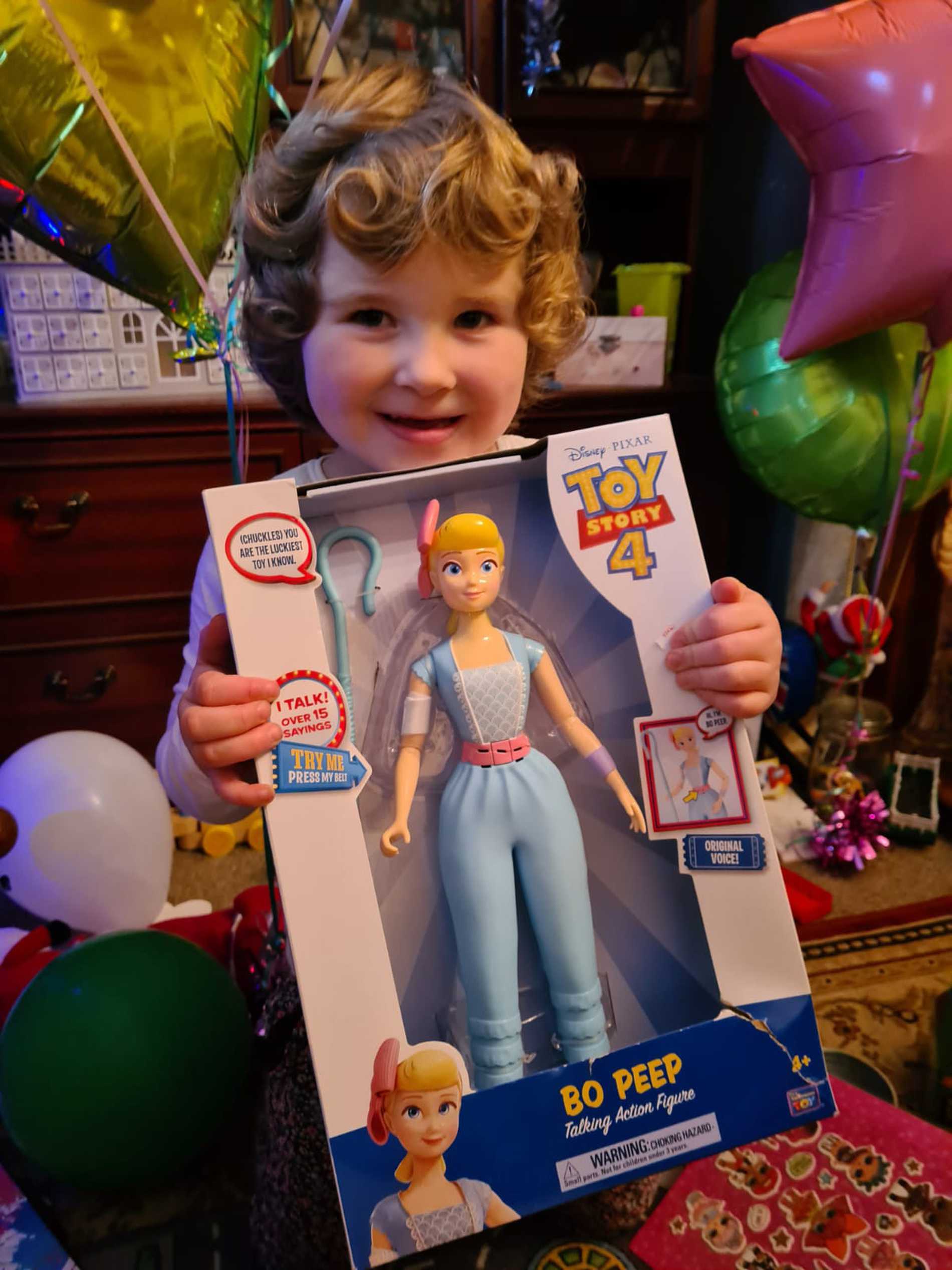 Leah clutching one of her presents, a new Barbie doll.