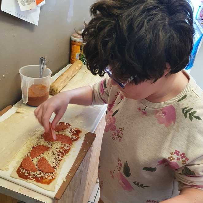 Dakota busy making pizza