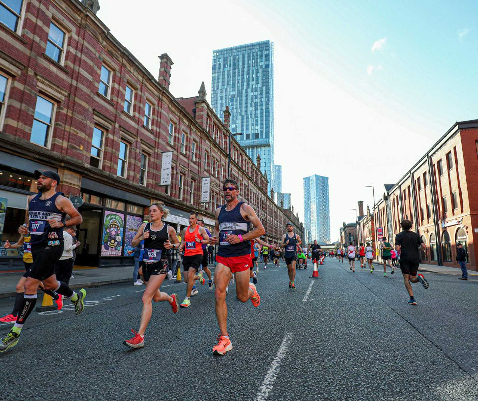 Manchester Marathon runners with the iconic Beetham Tower in the background.