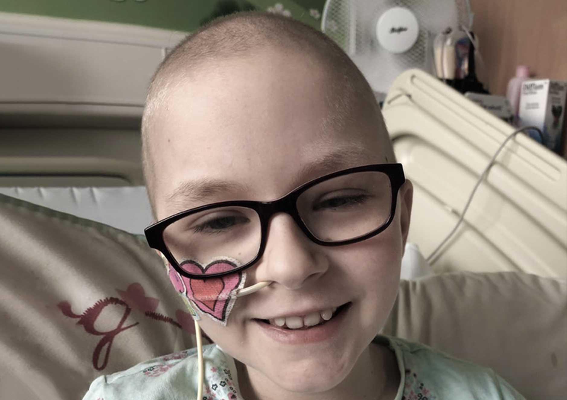 Wish child, Tilly, bravely smiling while undergoing treatment in hospital for osteosarcoma.