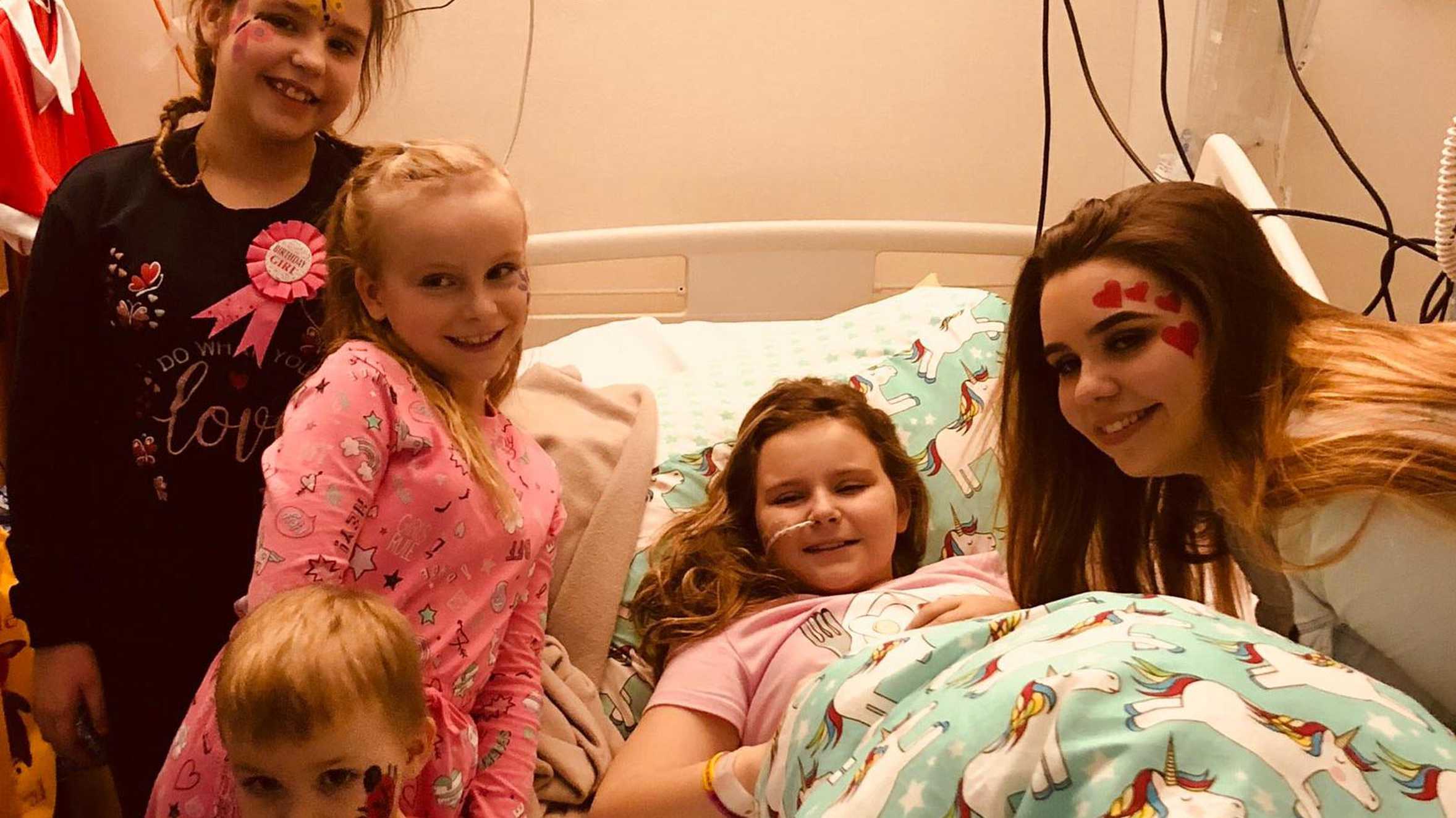 Amy with her friends and family in hospital