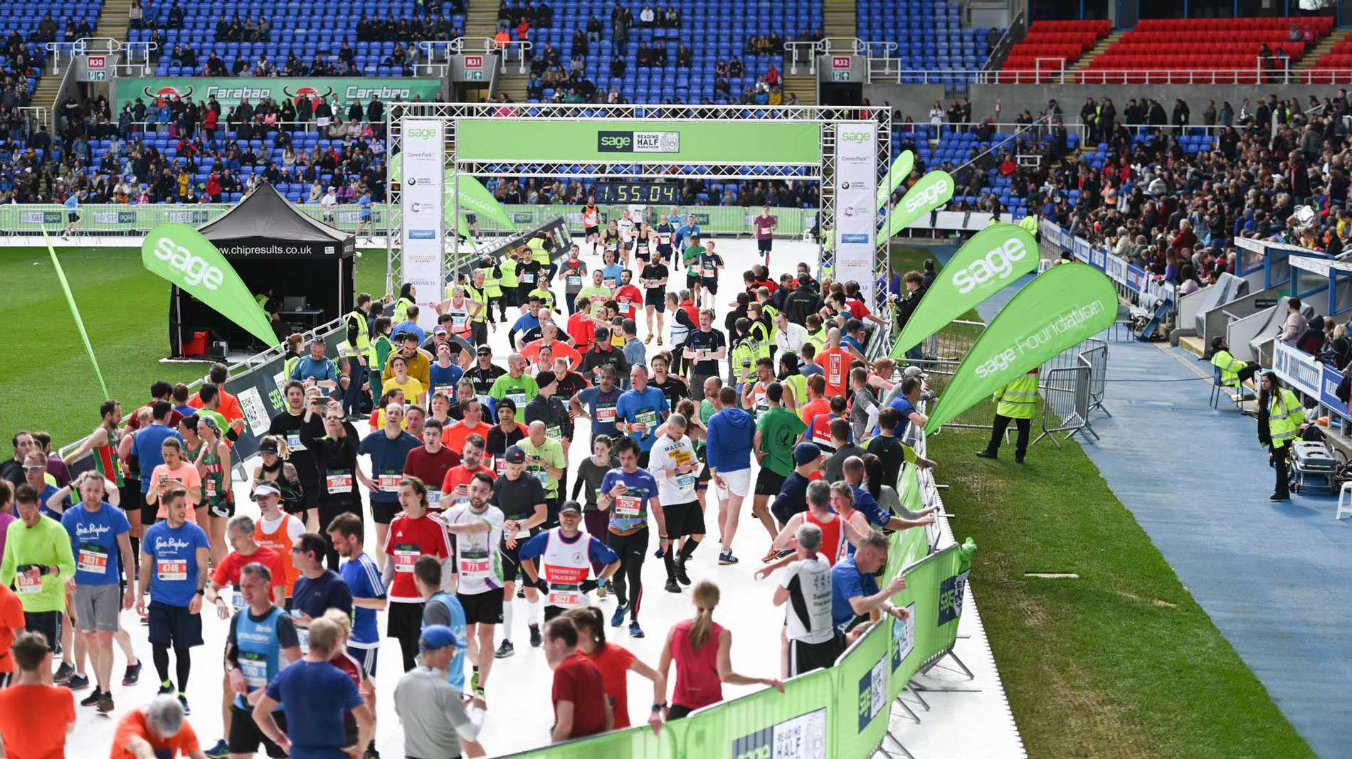 Runners arriving at the finish line of the Reading Half Marathon in the Madjeski Stadium.