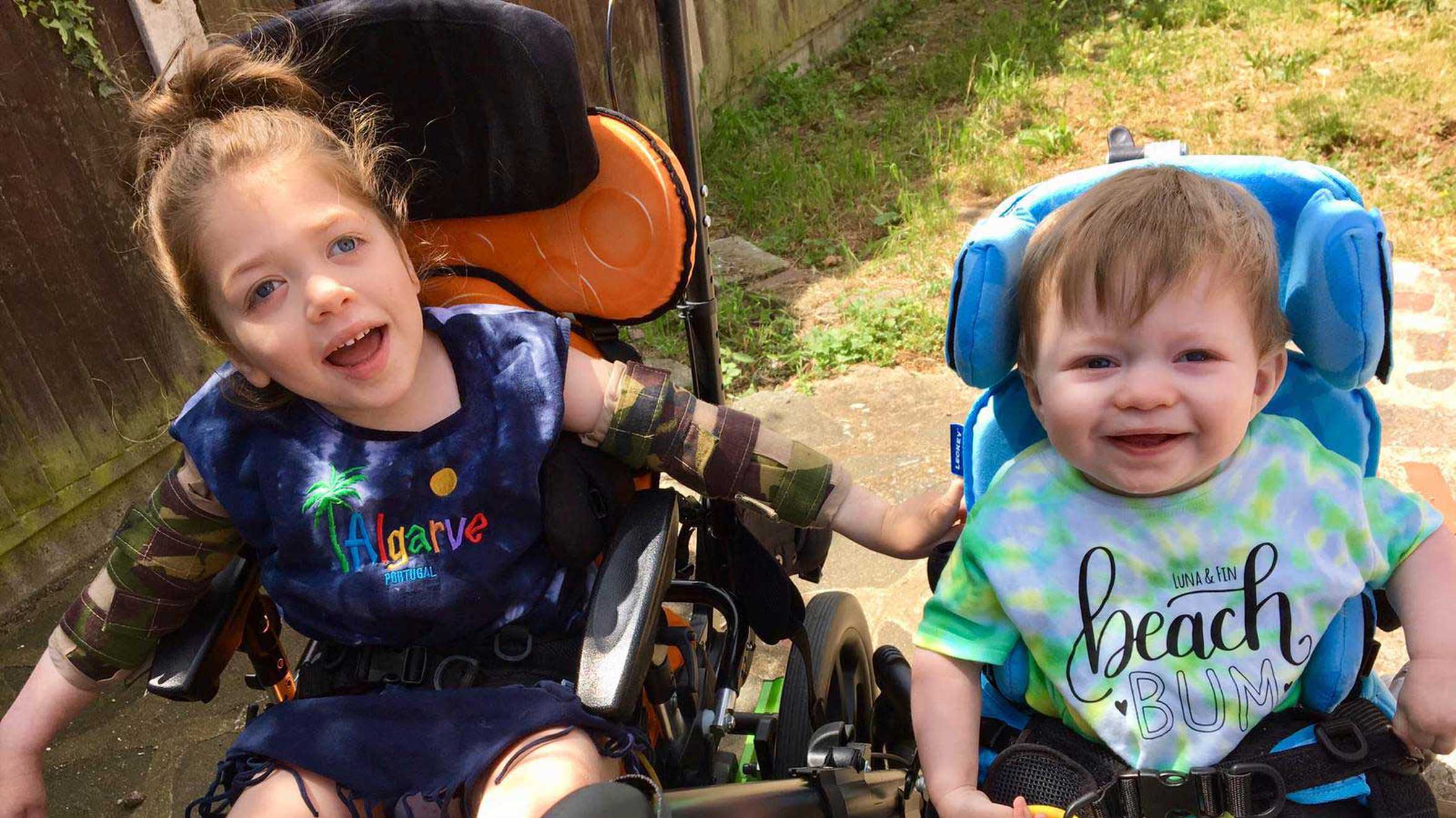 Aubree and her brother, together in the garden looking happy