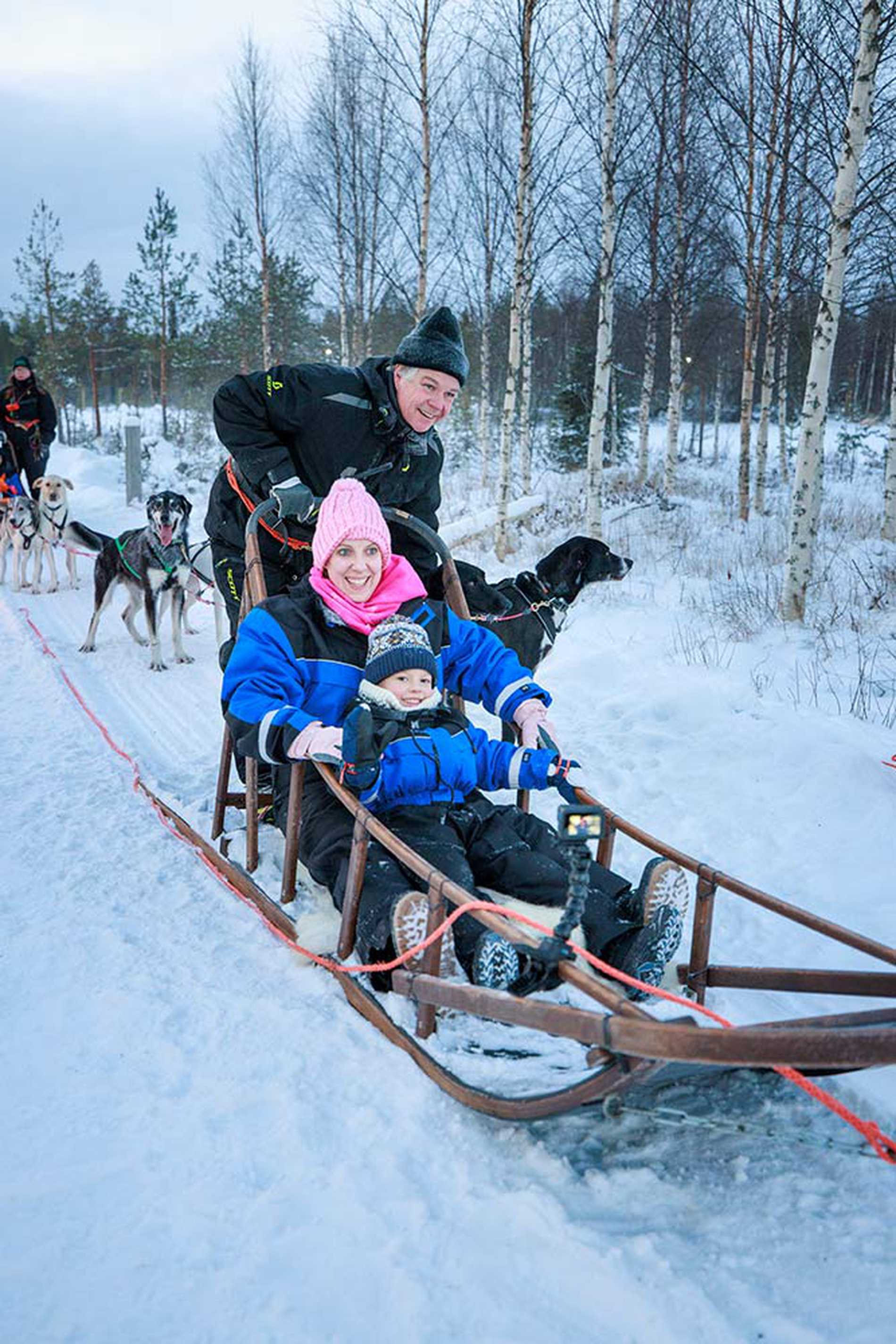 Mum and Jessie being taken on a dog sled ride.