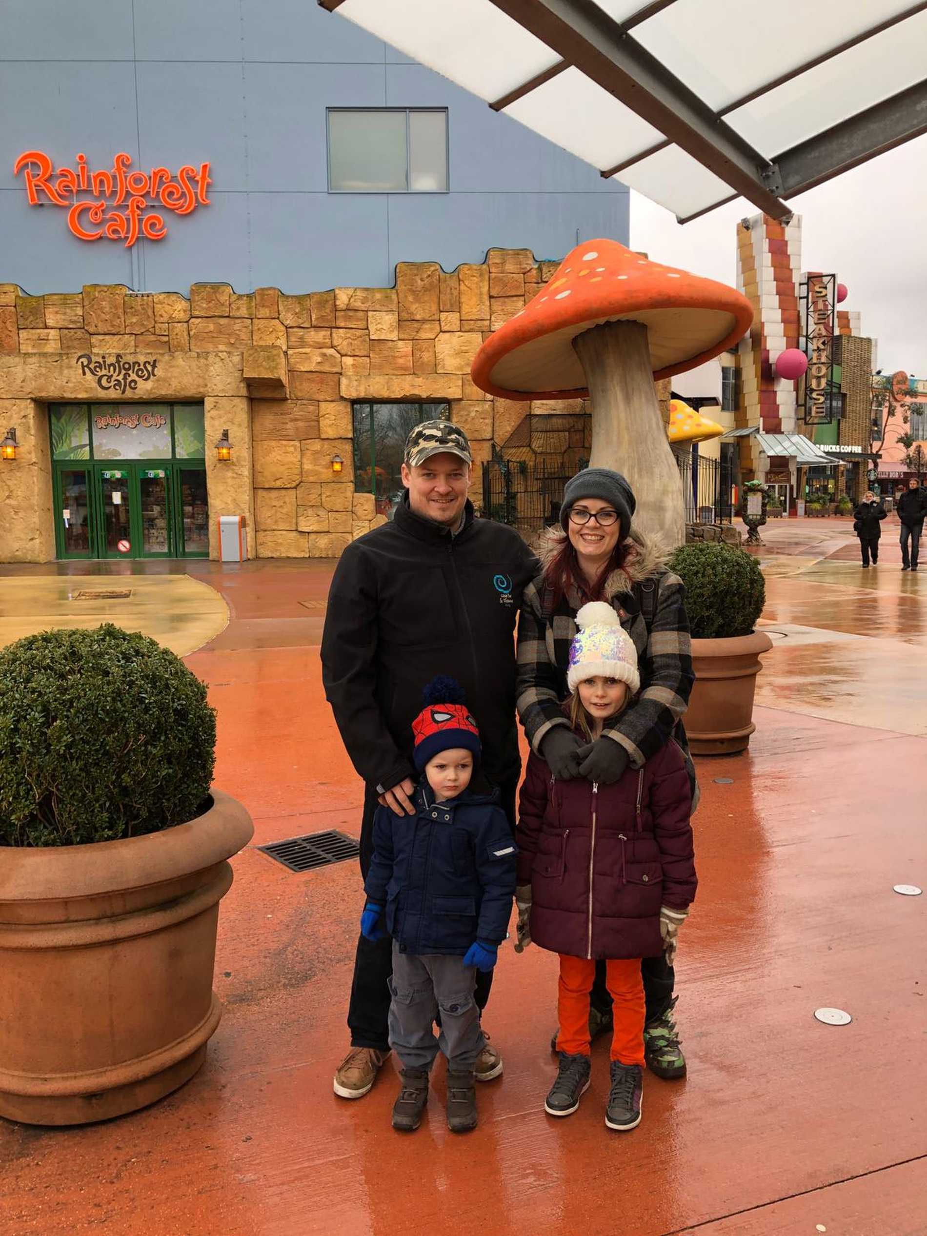 Ezekiel with his mum, dad and sister, outside the Rainforest Cafe at Disneyland Paris.