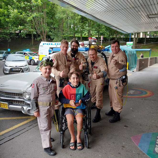 George and his fellow Ghostbusters with Ecto 1 outside Leeds Hospital.