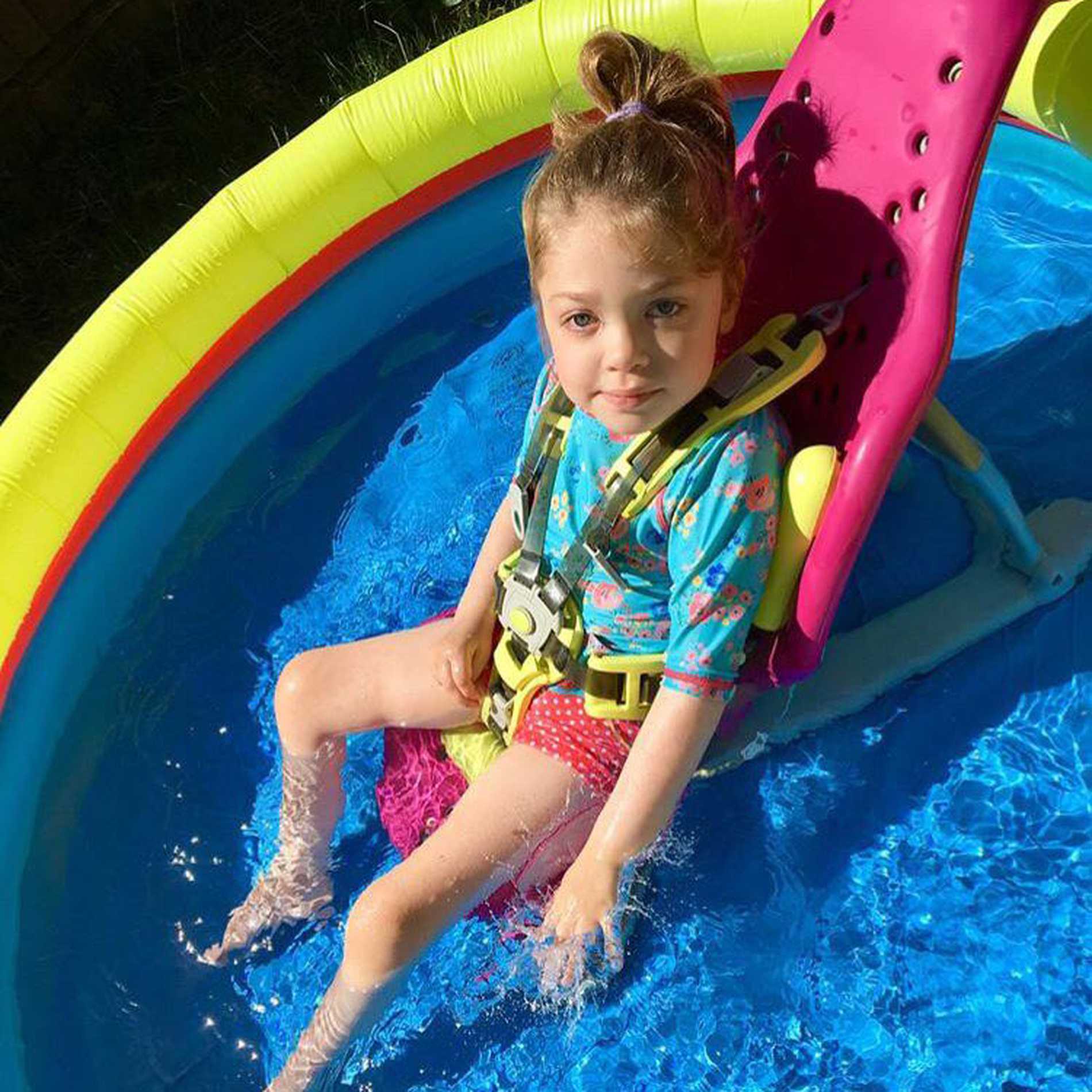 Aubree having fun in a paddling pool