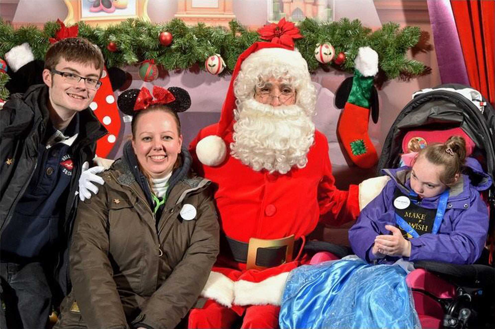 Alice, her mum and brother, meeting Santa Claus at Disneyland Paris.