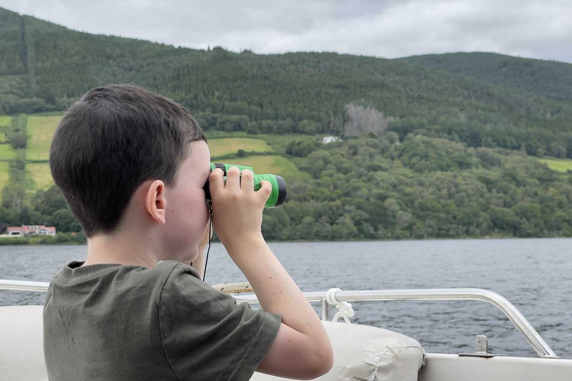 Harry searching for Nessie with his binoculars.