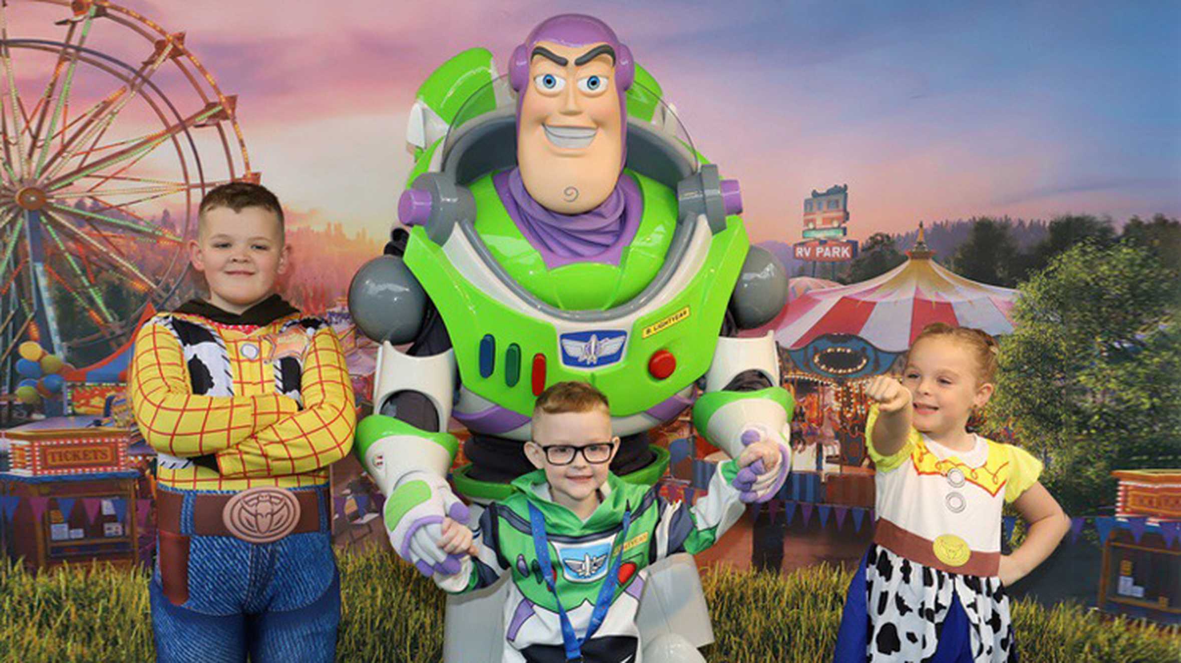 Patrick and his family posing with Buzz Lightyear from Toy Story.
