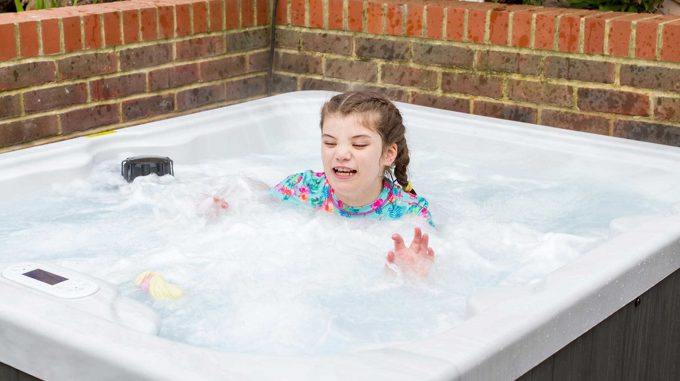 Wish child, Gracie, enjoying her new hot tub