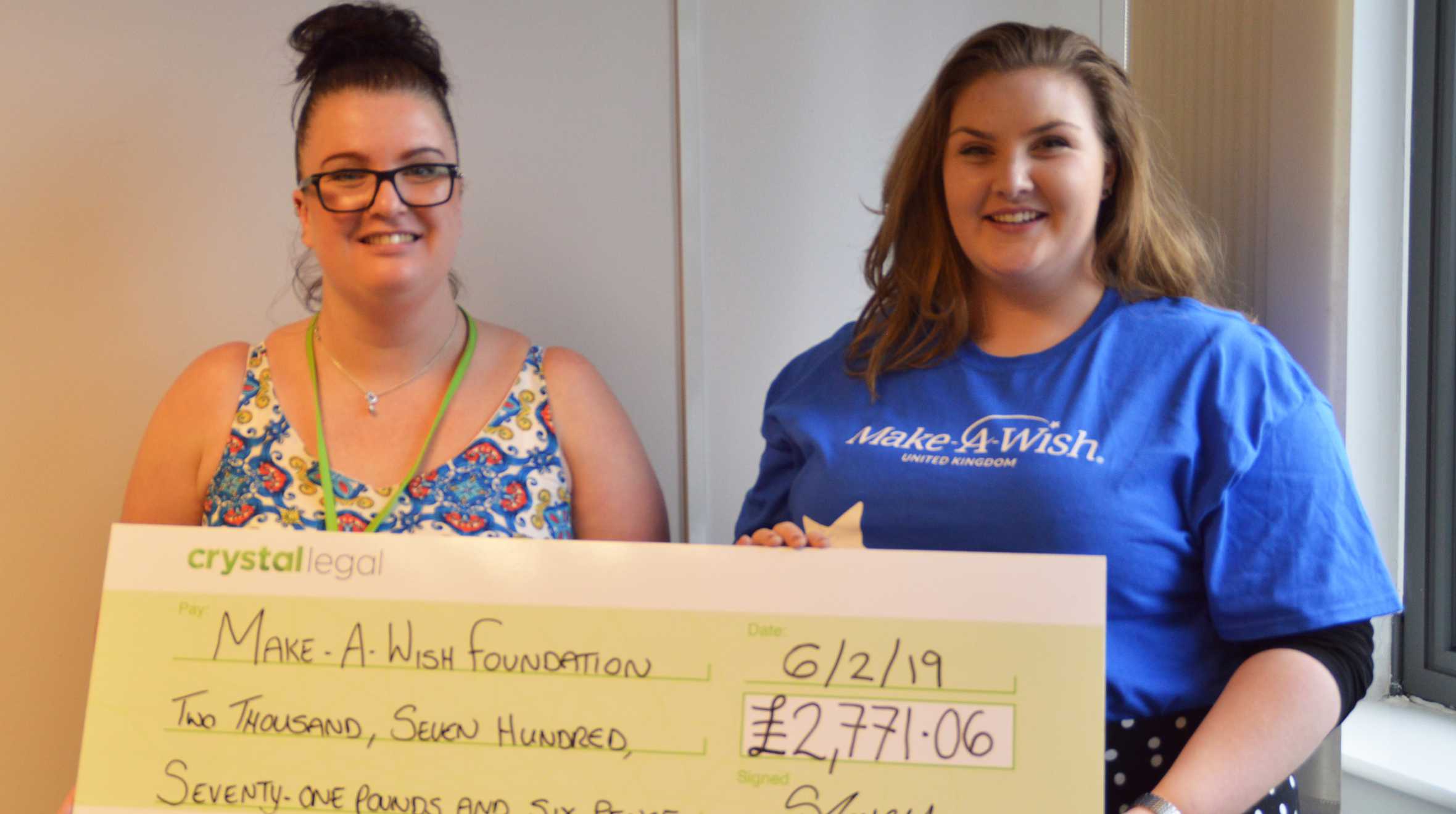 Grace receiving a cheque from a fundraiser