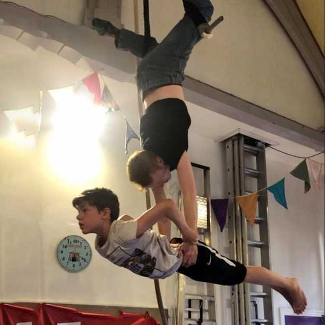 Sam and another child performing on the trapeze.