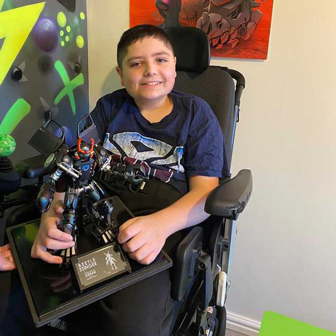 Kieran proudly holding his one-of-a-kind Beetle Stinger Transformer model.