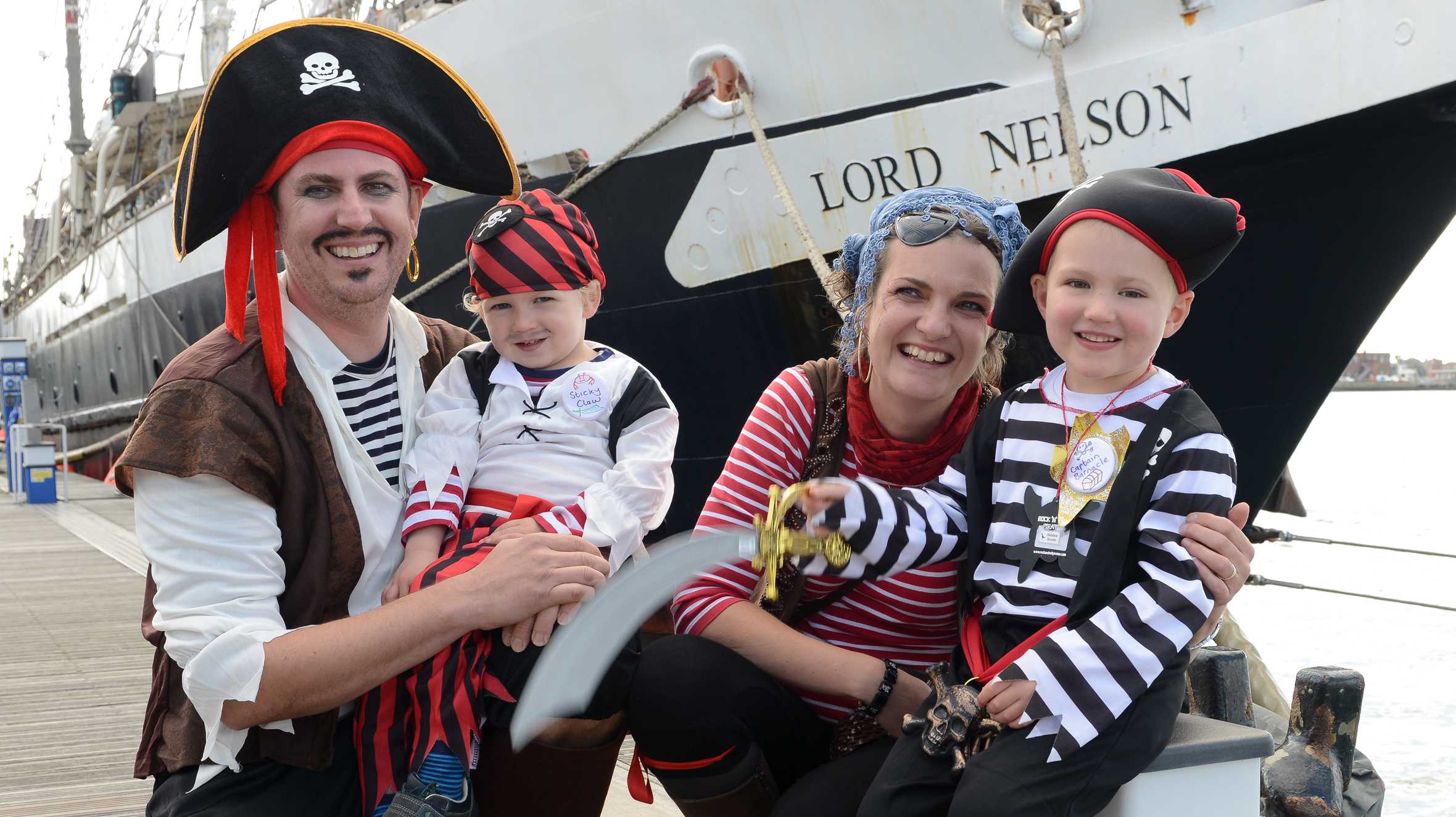 Sebbie and his family on his wish next to the ship