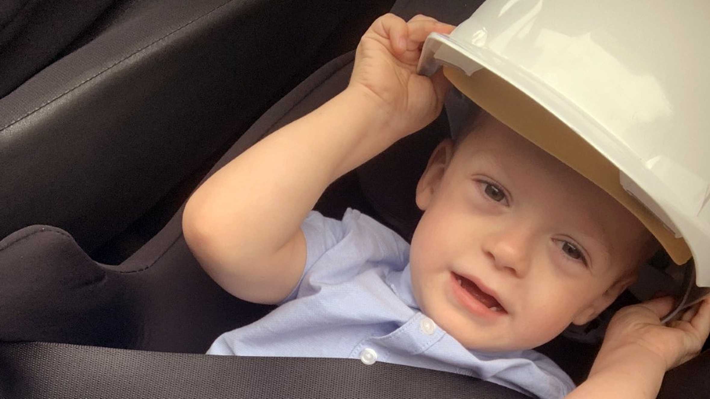 Frankie putting on a builder's hard hat