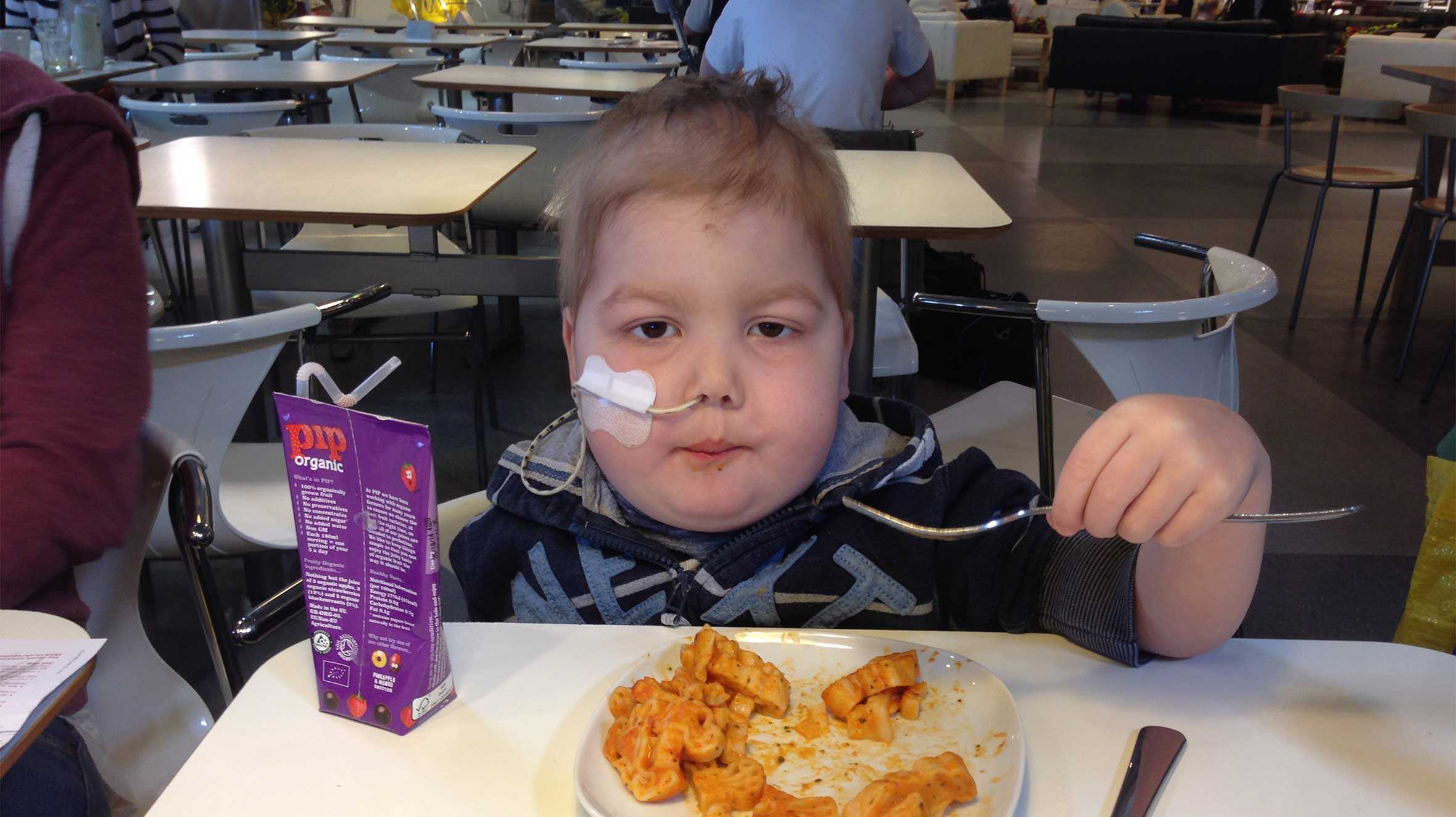 Jacob eating in the hospital canteen while undergoing treatment