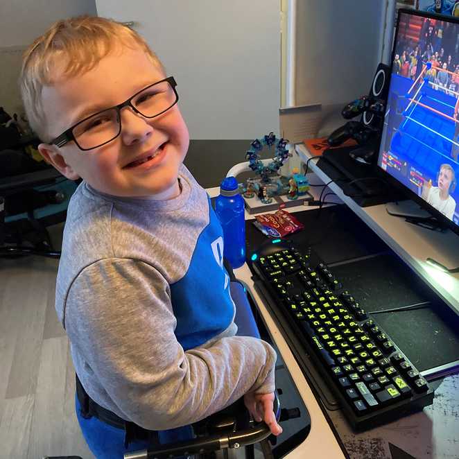 A smiling Harrison in front of his new gaming PC.