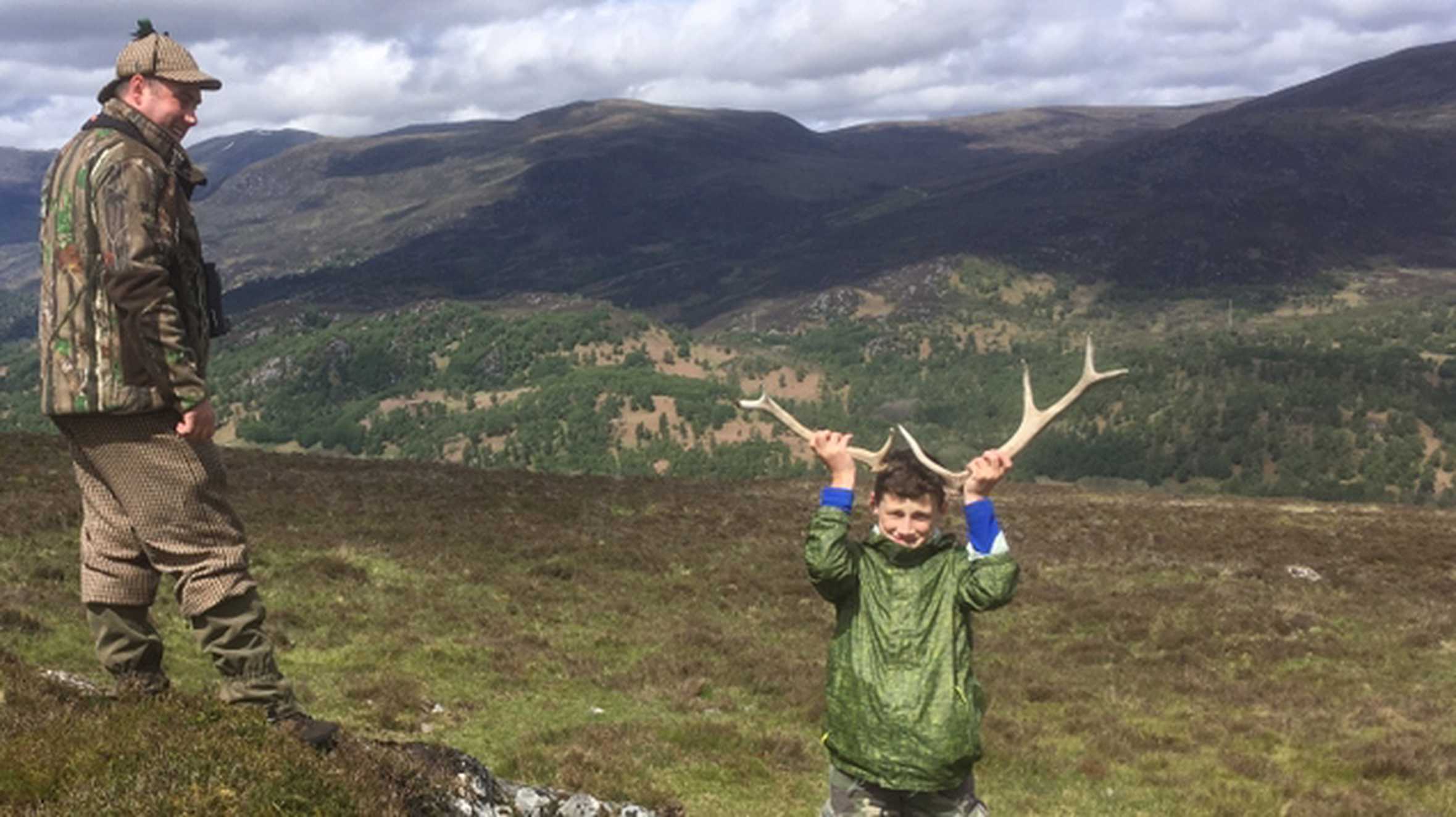 Wish child Brandon holding antlers on his wish in the Scottish Highlands