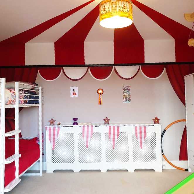 A red and white, big top-themed canopy hangs over Lottie's bunk bed.