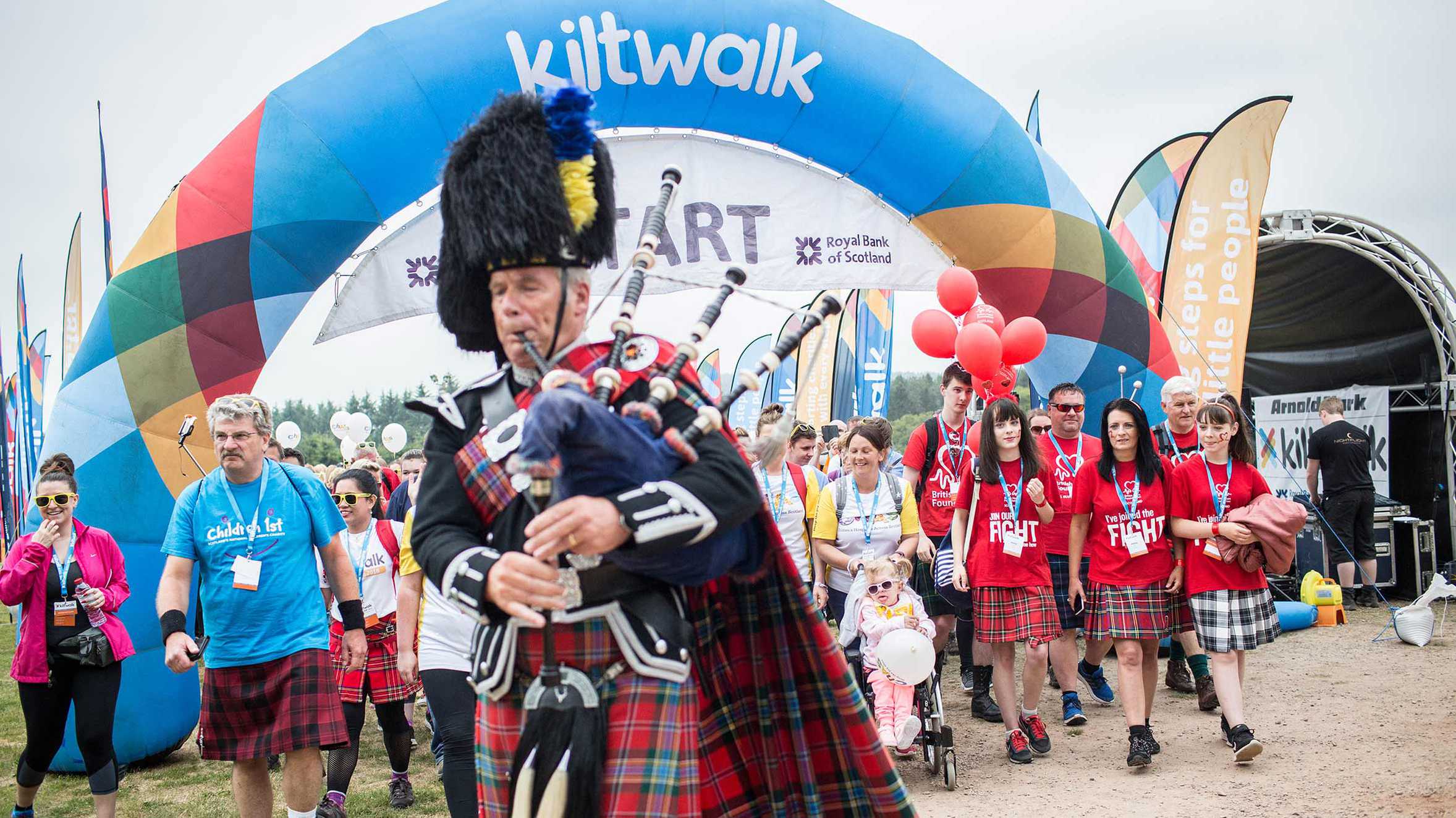 A crowd of enthusiastic walkers setting off on the Kiltwalk
