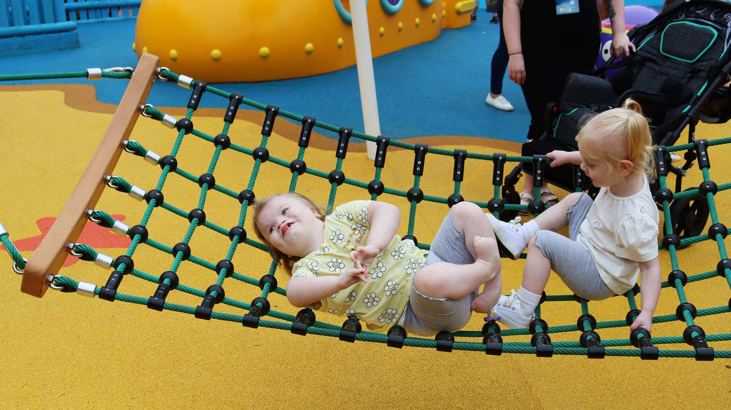 Bella-Rose laying in a net hammock during her trip to CBeebies Land.