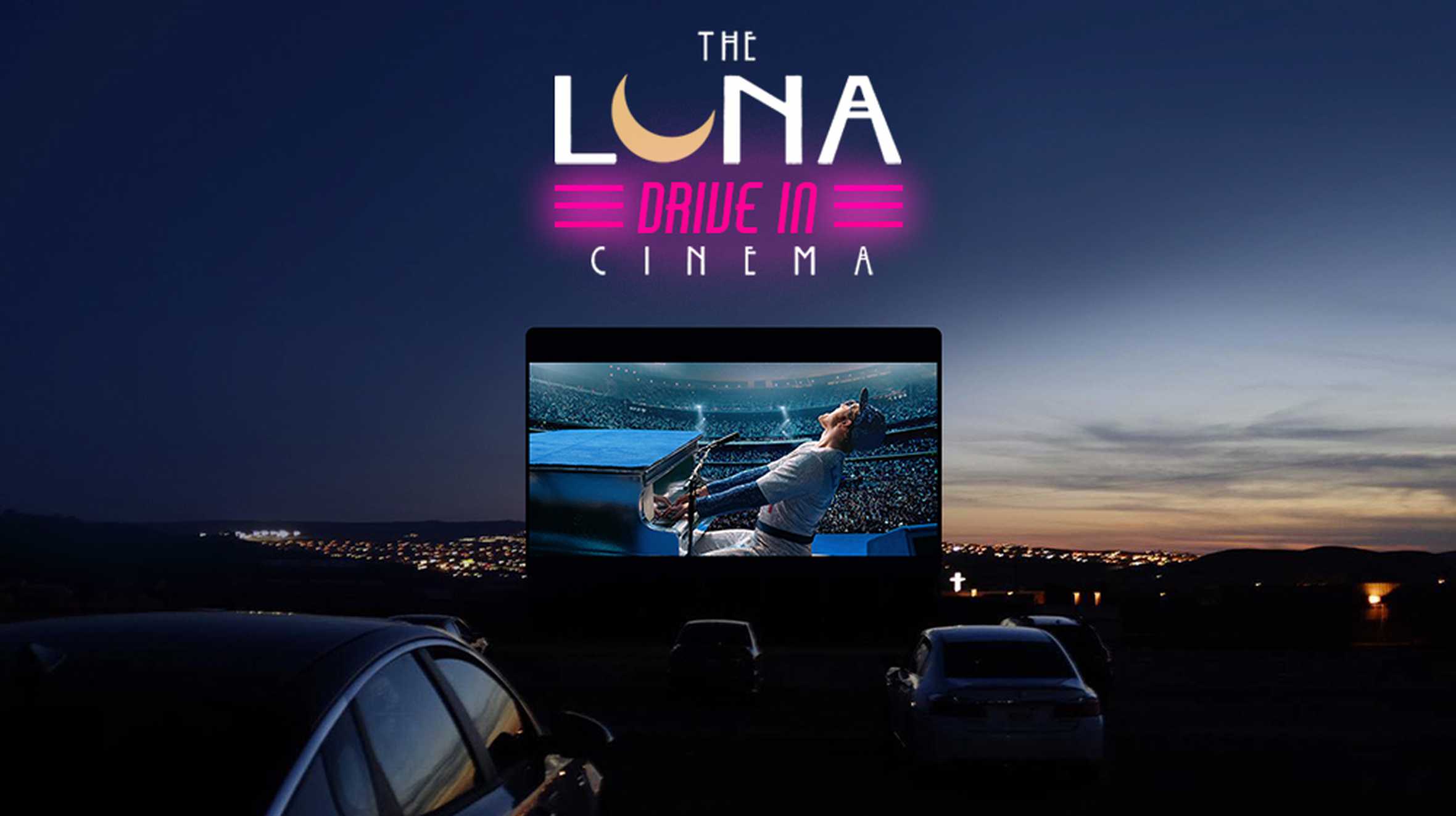 Cars in front of a drive-in movie screen at sunset, with the Luna Cinema logo in neon lights.