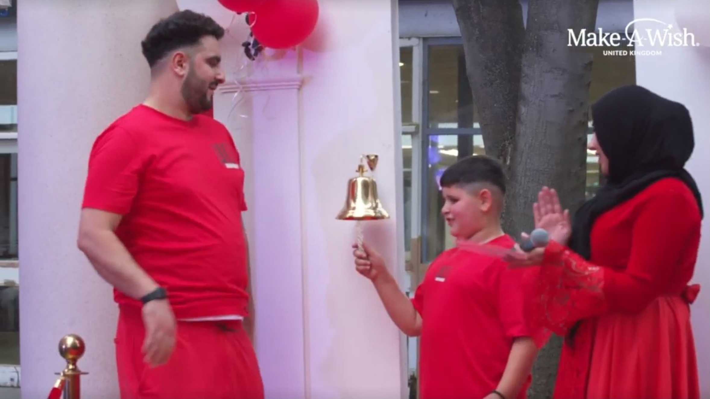 Adil ringing the bell to signify the end of his treatment.